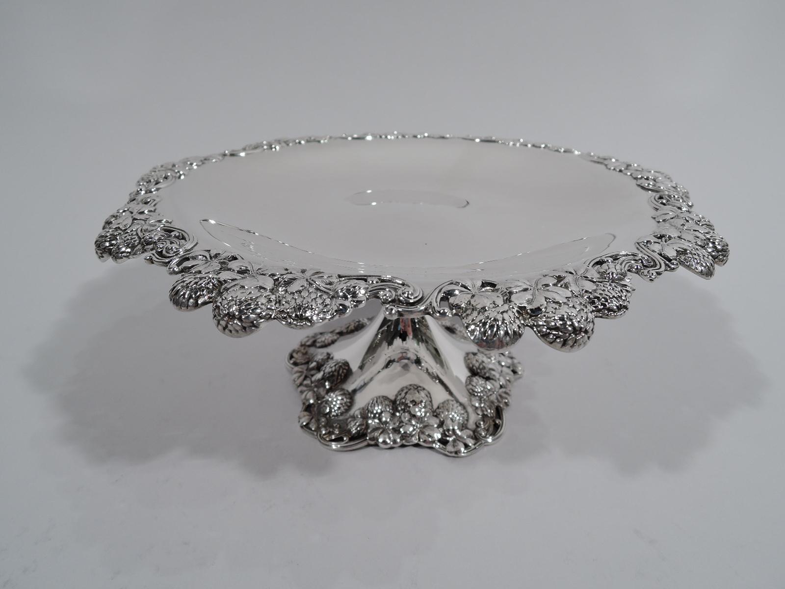 Pair of Clover sterling silver compotes. Made by Tiffany & Co. in New York. Plain and shallow bowl. Rim irregular and pierced with pell-mell flower heads. Raised foot same. Great pieces in the Classic high-low pattern that combines wildflowers and