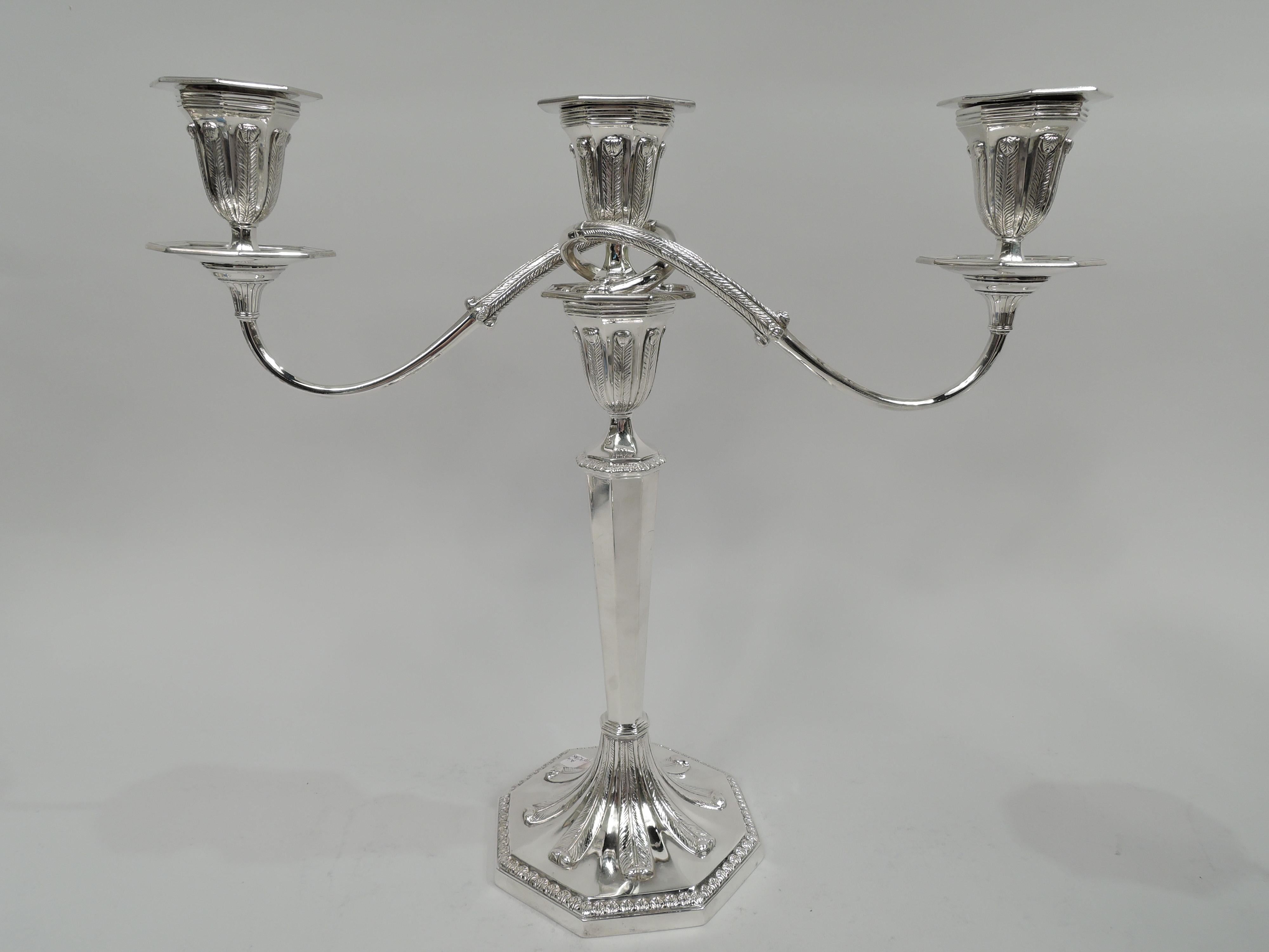 Pair of English Neoclassical sterling silver 3-light candelabra. Made by Tiffany & Co. in New York, ca 1928. Each: Two leaf-wrapped arms, each terminating in single socket, wrapped around a central socket. Arms set in single socket mounted to