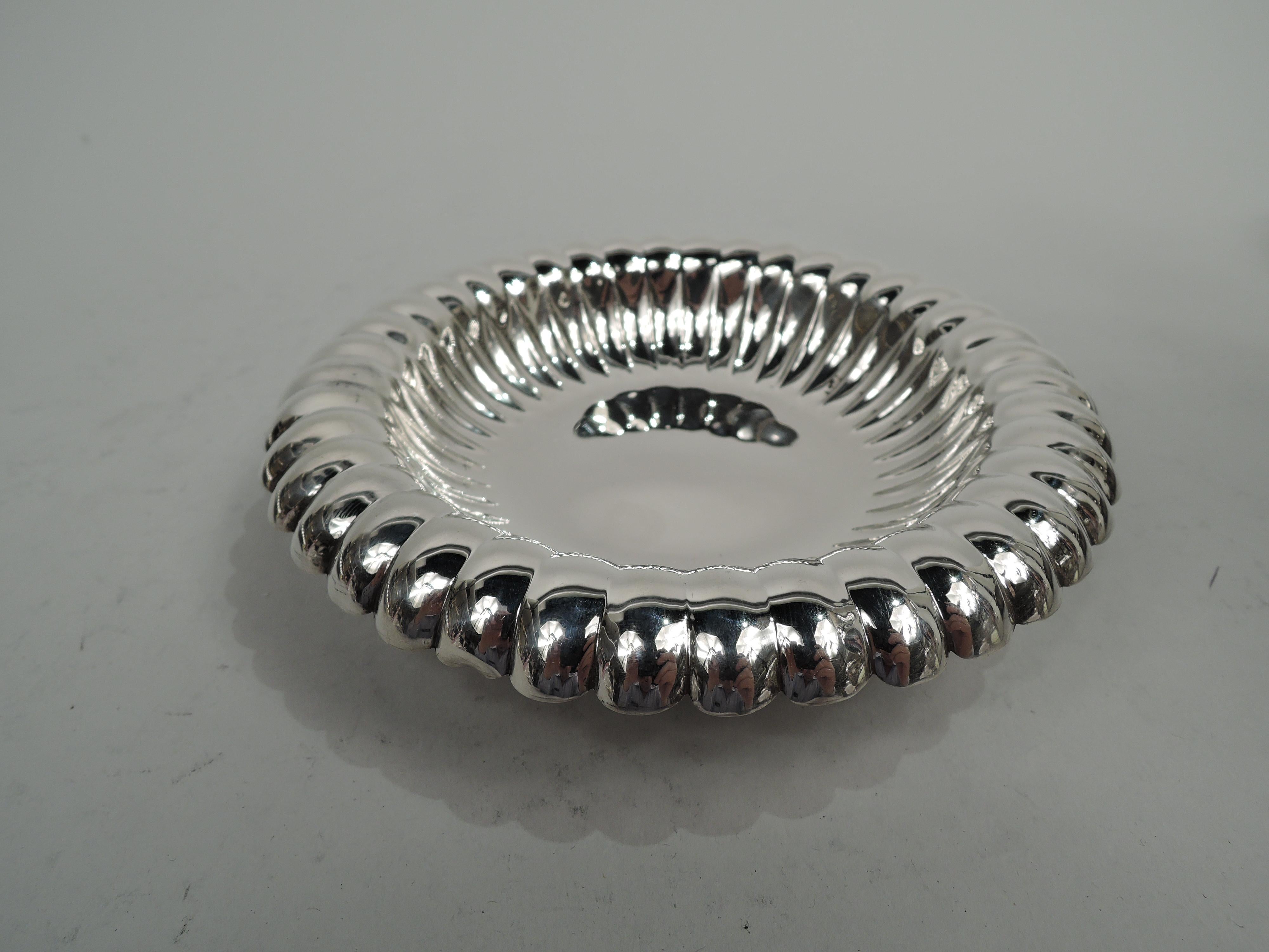 Pair of Victorian Classical sterling silver bowls. Made by Tiffany & Co. in New York. Each: Round with plain well and curved and fluted sides. Turned-down lobed rim. Four ball supports Fully marked including maker’s stamp, pattern no. 10374 (first