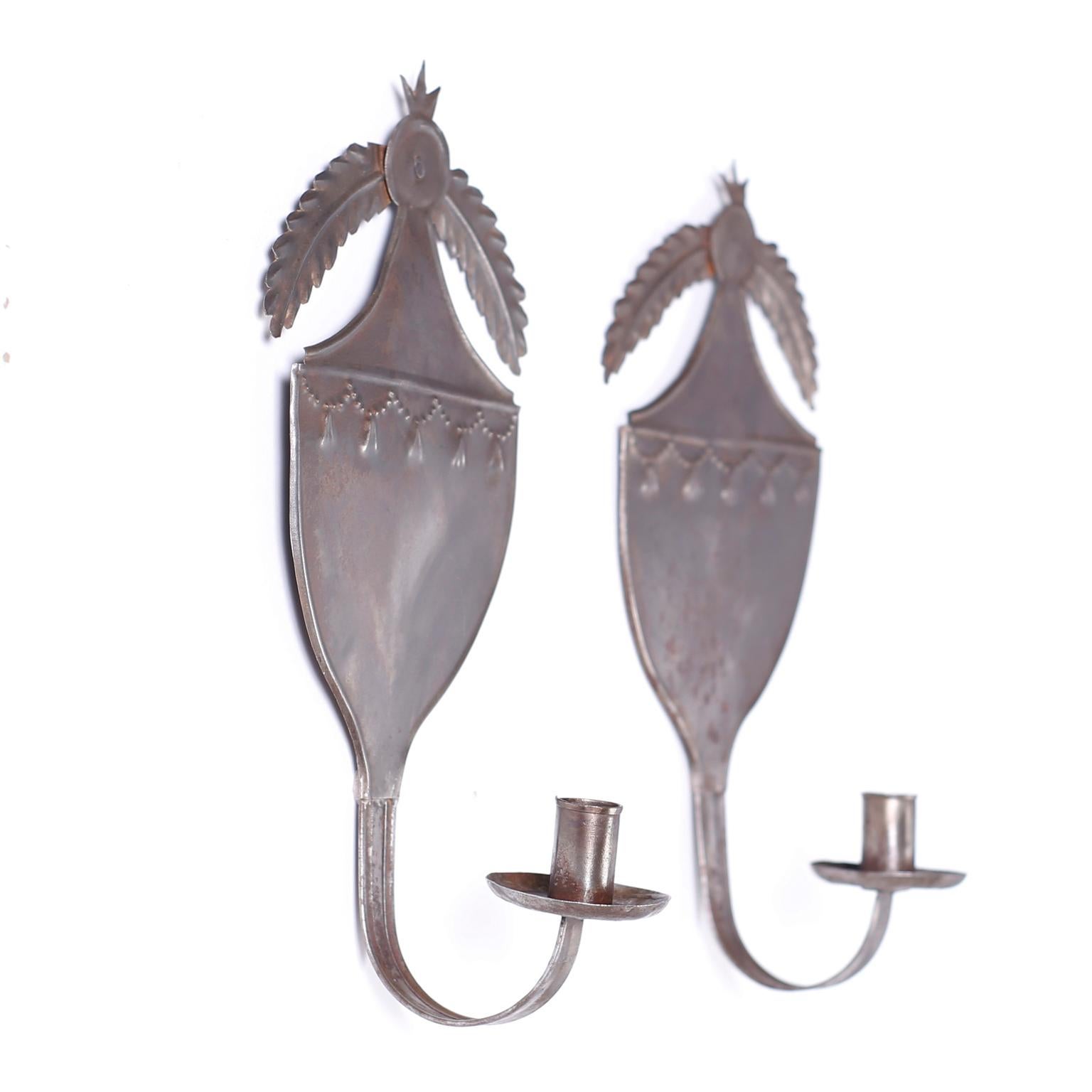 Antique pair of French handmade wall sconces with influences from the Empire or Regency style with a perfect aged oxidized finish.