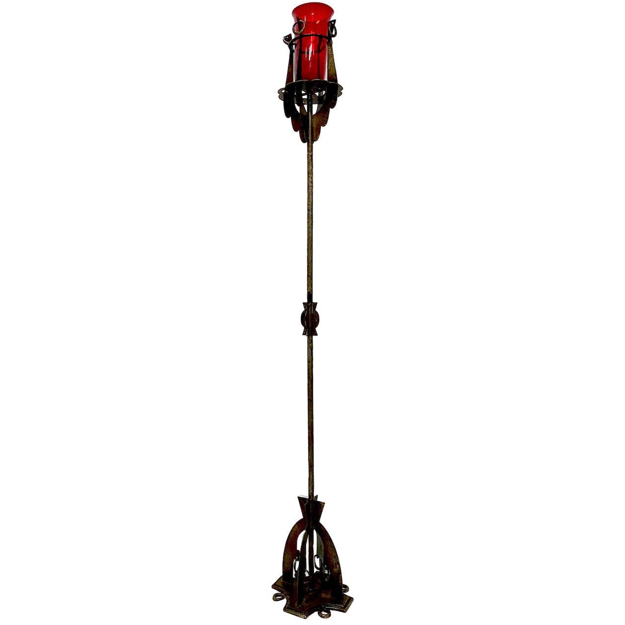 A pair of circa 1900 French wrought iron torchère floor lamps with ruby red glass inset.

Measurements:
Height 68