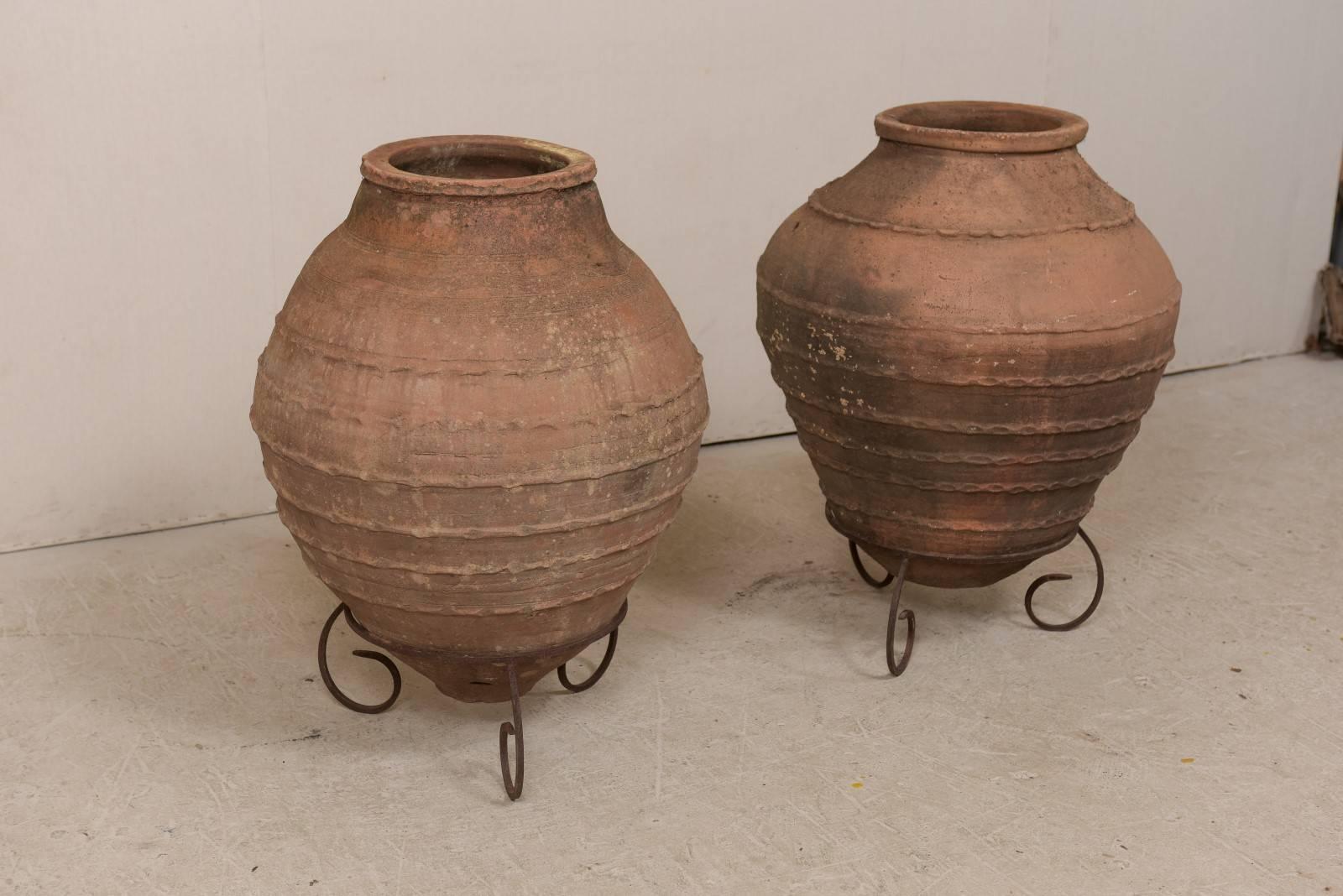 Spanish Colonial Pair of Antique Turkish Olive Jars Made of Terracotta on Scrolled Metal Stands
