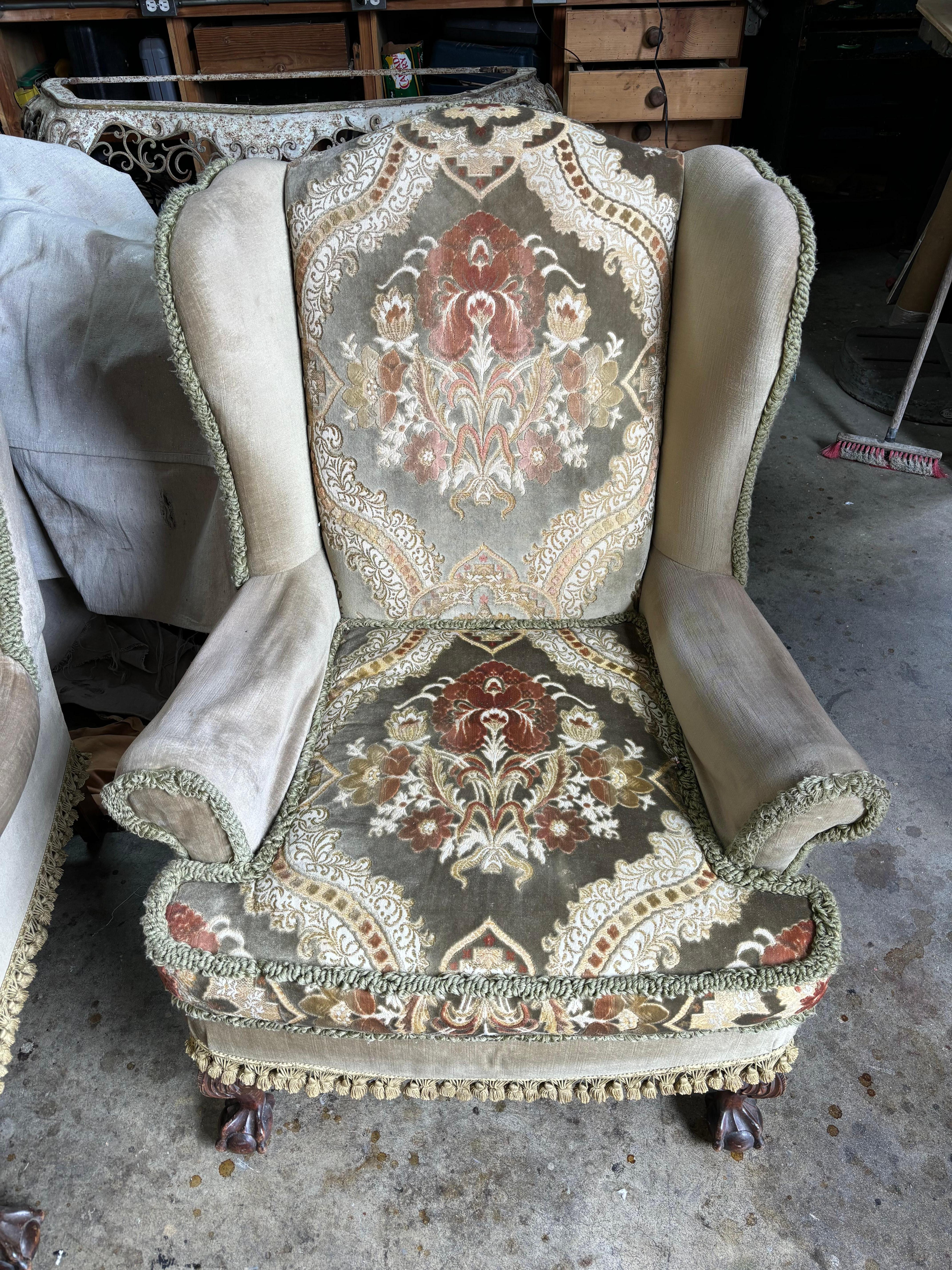 1920s Upholstered Wing Back Armchair on walnut cabriole legs.

Beautiful fabric. Tassels hanging at the bottom from the chair. 