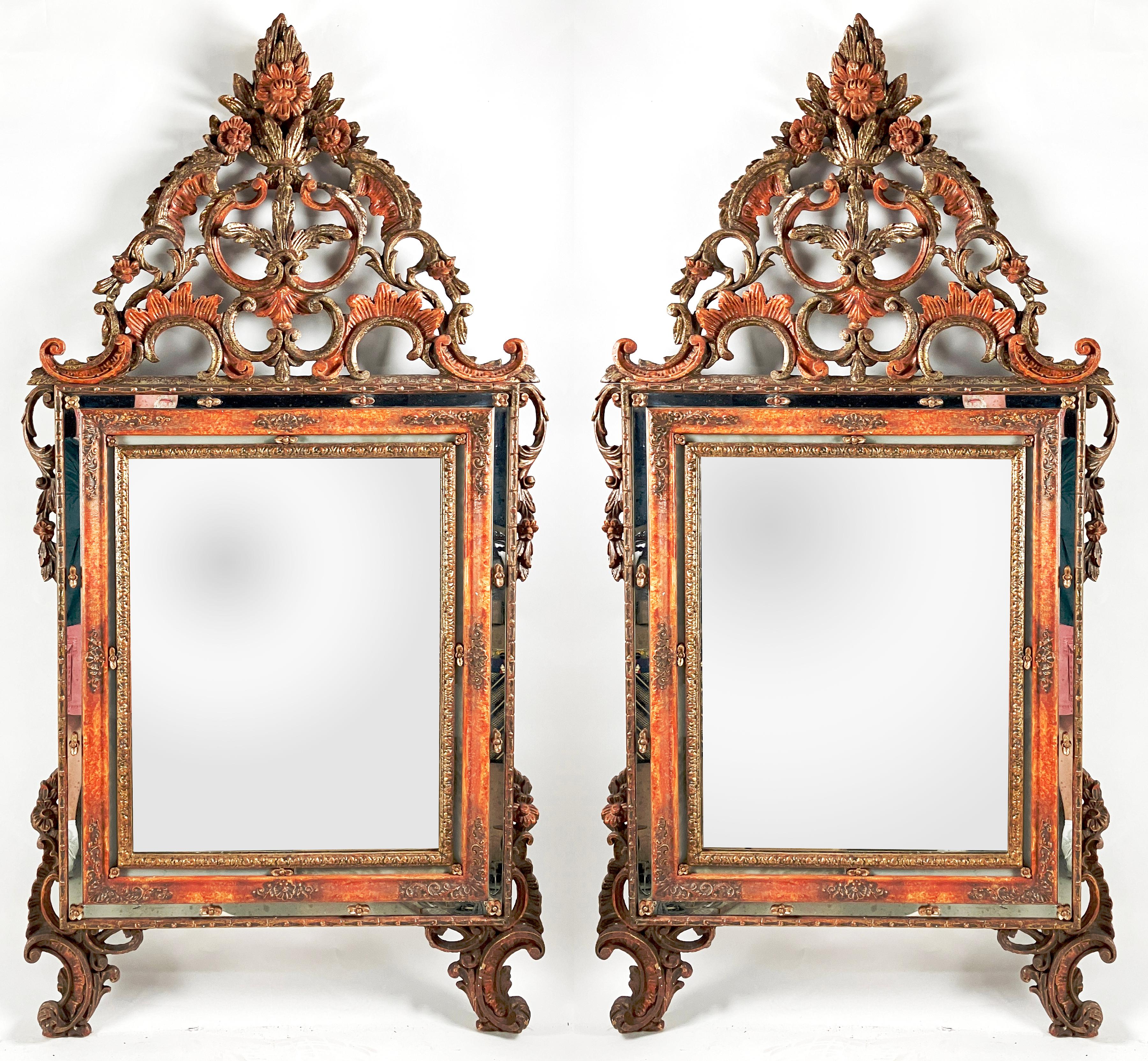 

Hand-crafted in Italy in the early 1800s, this pair of polychrome Venetian mirrors have gilded carvings offset by floral paint. The shaped mirrors are surrounded by a border festooned with repeating applied decorations. There is a gilt-raised