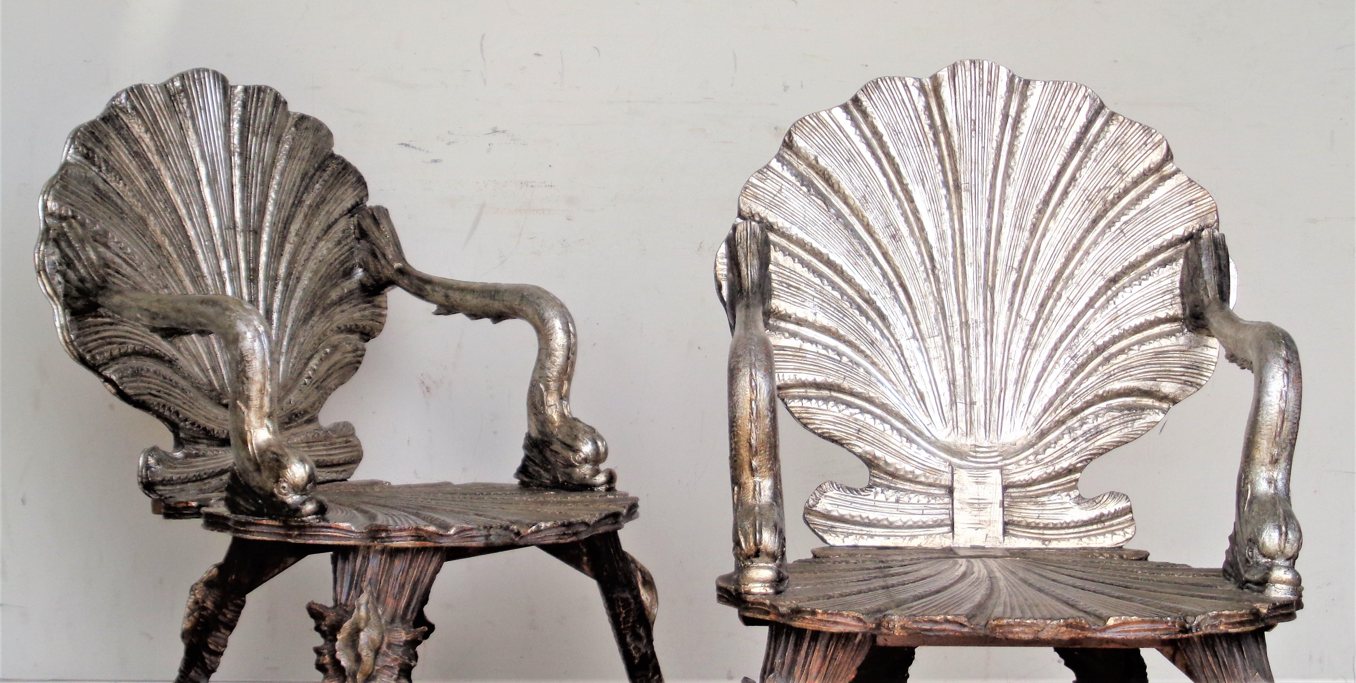 Pair of antique Venetian grotto chairs with well detailed carved dolphin arms / shell backs / conch legs. Both chairs in overall beautiful silvered and gilt burnished finish. In the style of the retailer - Pauly et Cie, circa 1900. Look at all