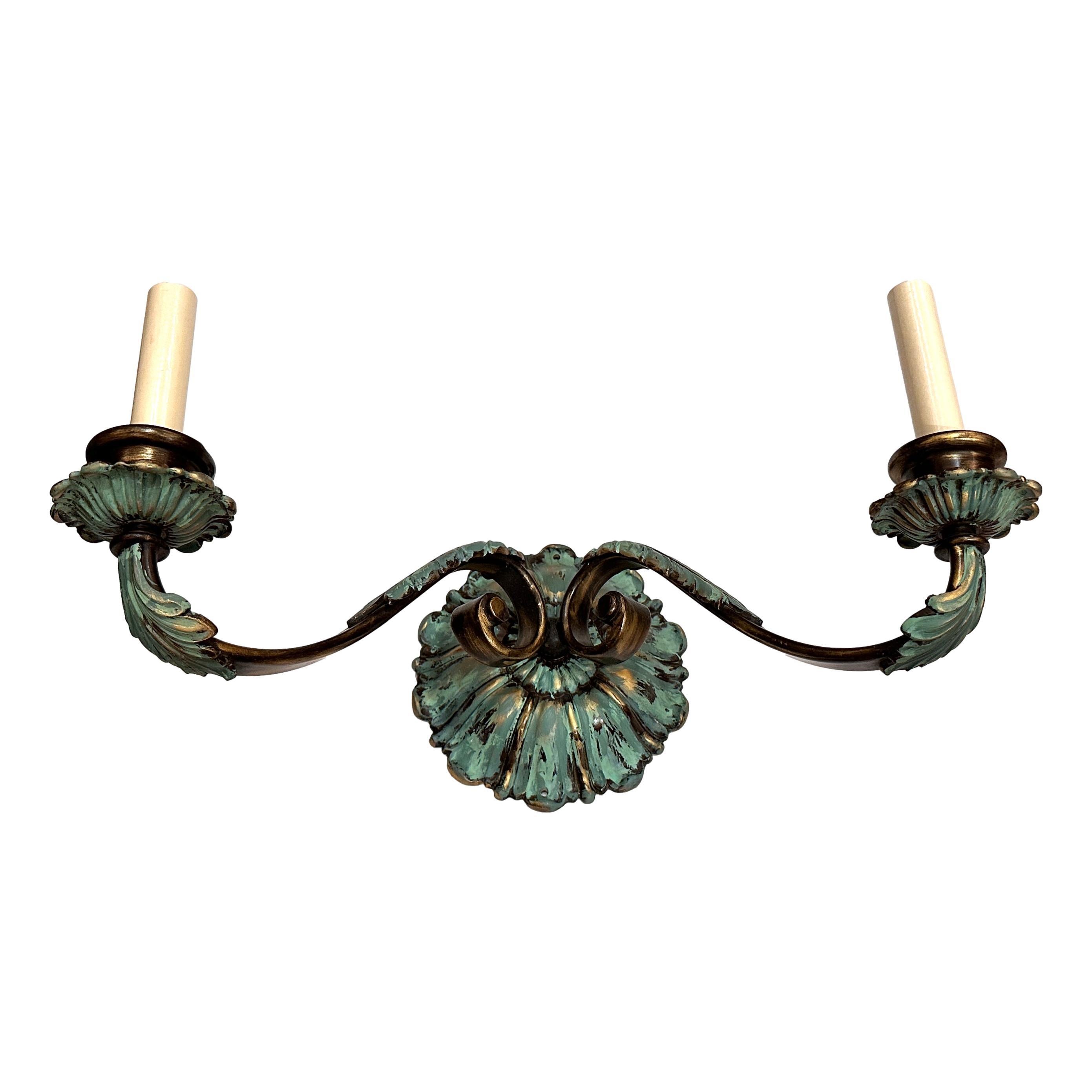 Pair of circa 1900 French cast bronze sconces with verdigris and gilt finish.

Measurements:
Height: 7