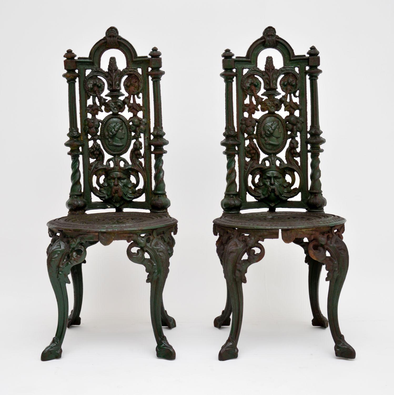 Pair of antique Victorian cast iron garden chairs in good original condition and with many fine details. They are still showing the original green paint and have weathered a lot over the years, so have a nice distressed look now. These chairs date