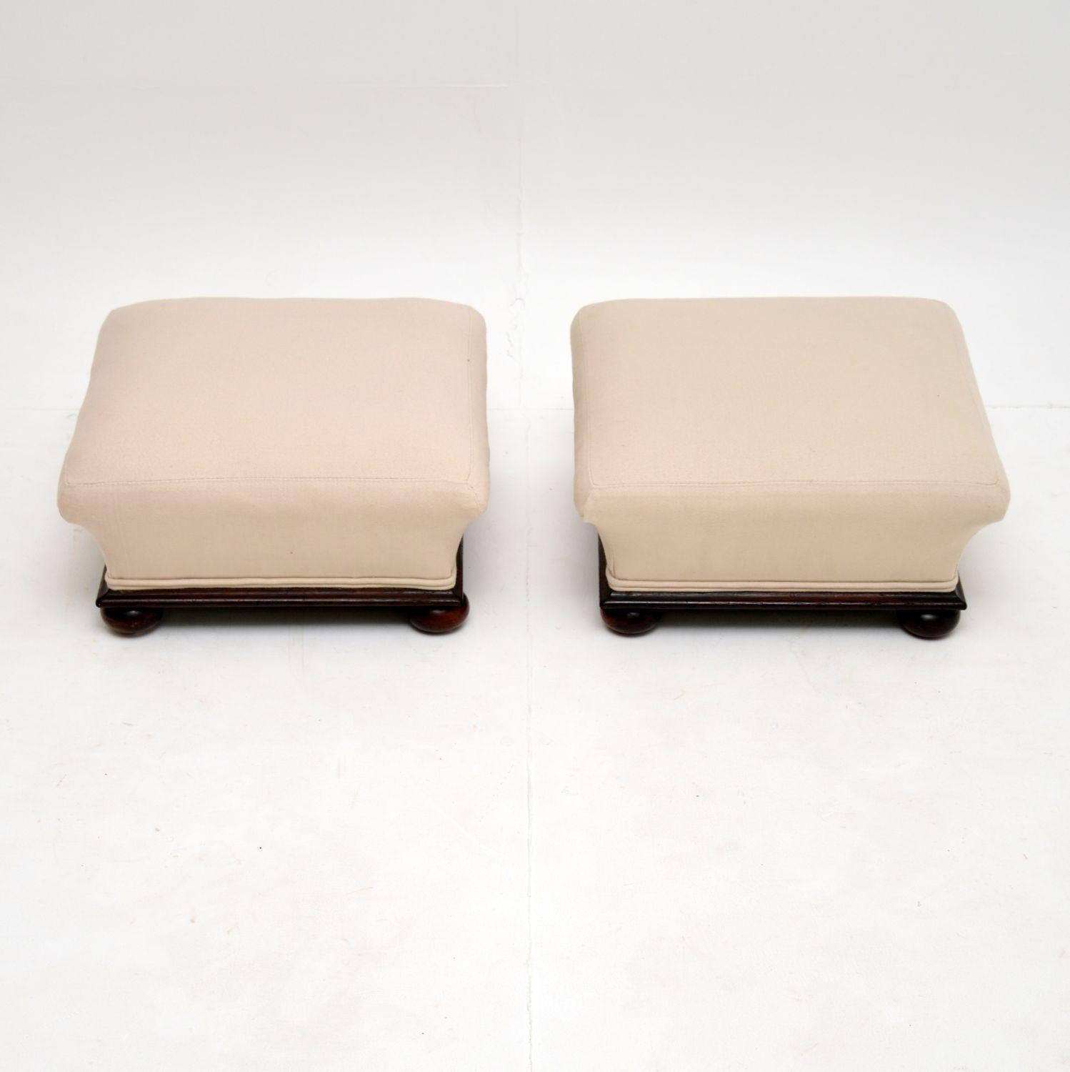 A beautiful shaped and very well made pair of Victorian foot stools, dating from circa 1860-1880 period.

They have solid polished wood bases with bun feet. We have had these fully re-upholstered in our cream cotton fabric, they are in excellent