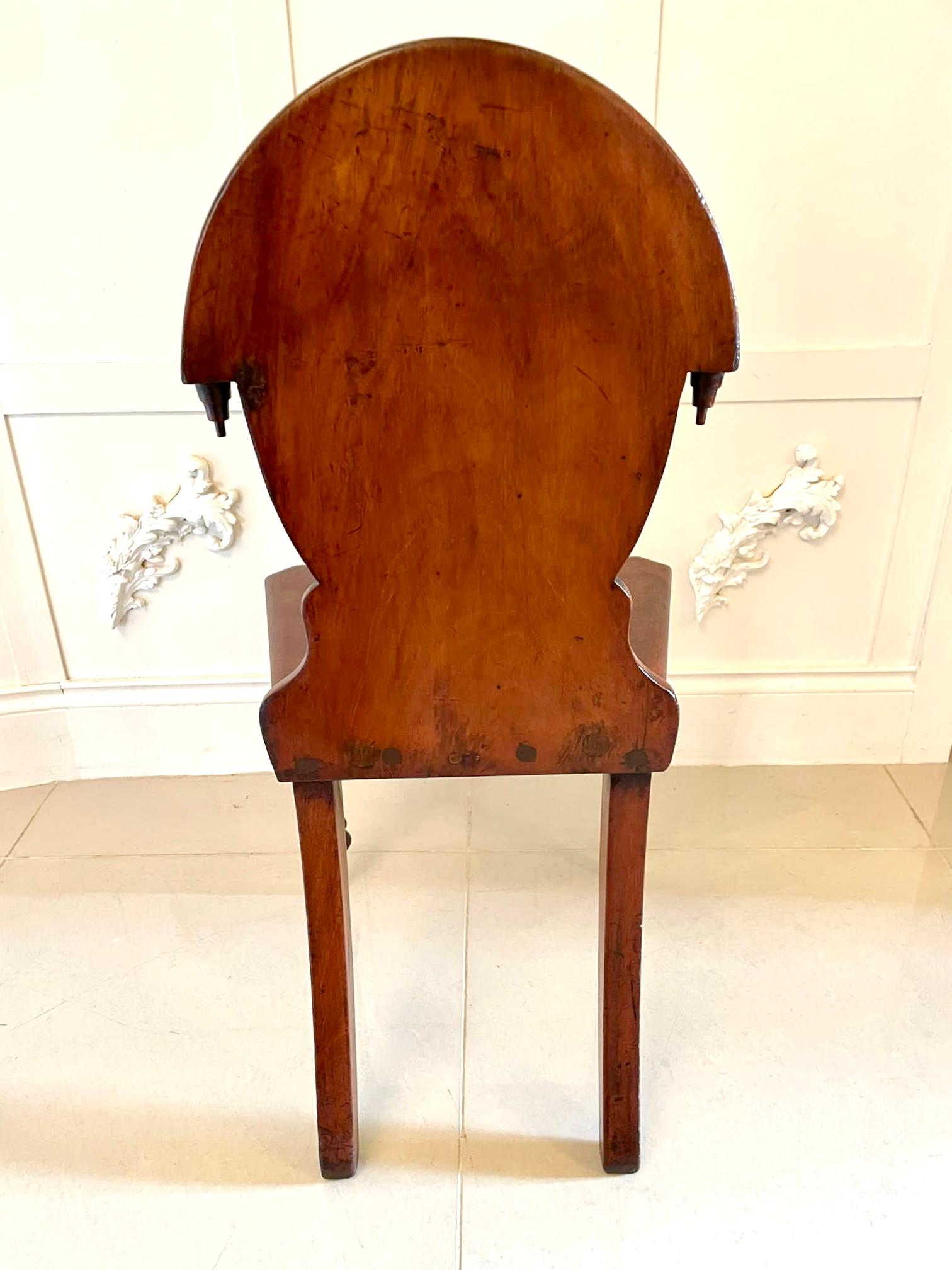 Pair of antique Victorian mahogany hall chairs having an oval shaped mahogany carved back, mahogany seats and standing on shaped turned tapering legs to the front and out swept back legs.

Handsome examples with a desirable colour and