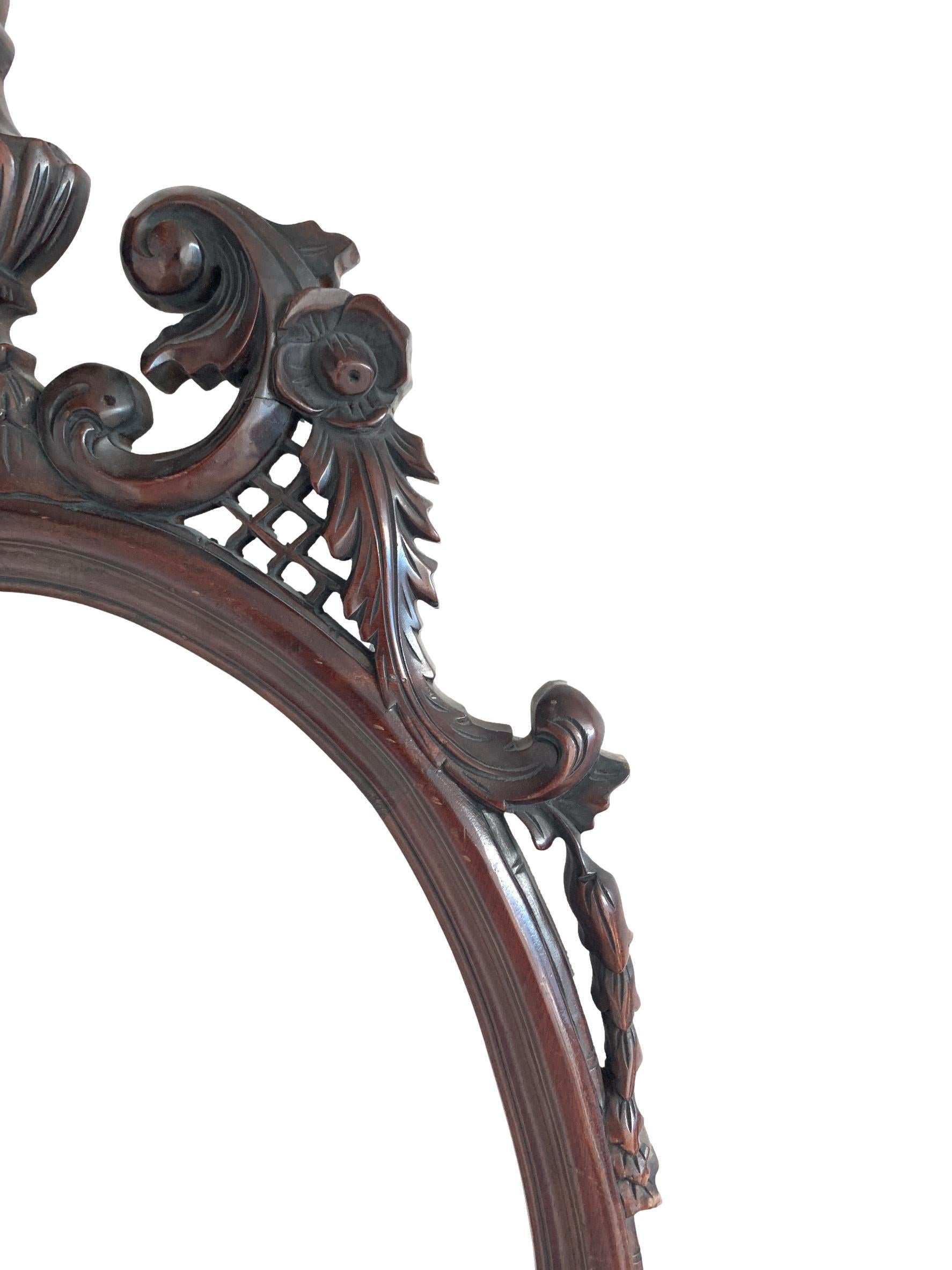 A finely carved antique English Victorian mahogany oval wall mirrors, circa 1850.
 