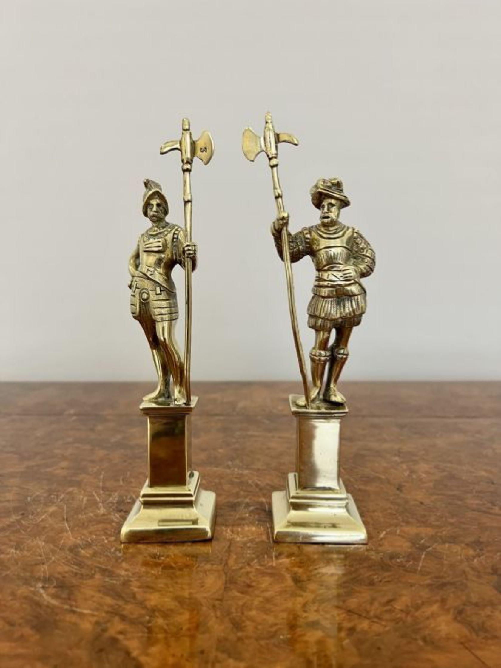 Pair of antique Victorian quality brass figures of cavaliers having a pair of cavaliers standing on brass pedestals holding a brass battle axe dressed in original clothing 