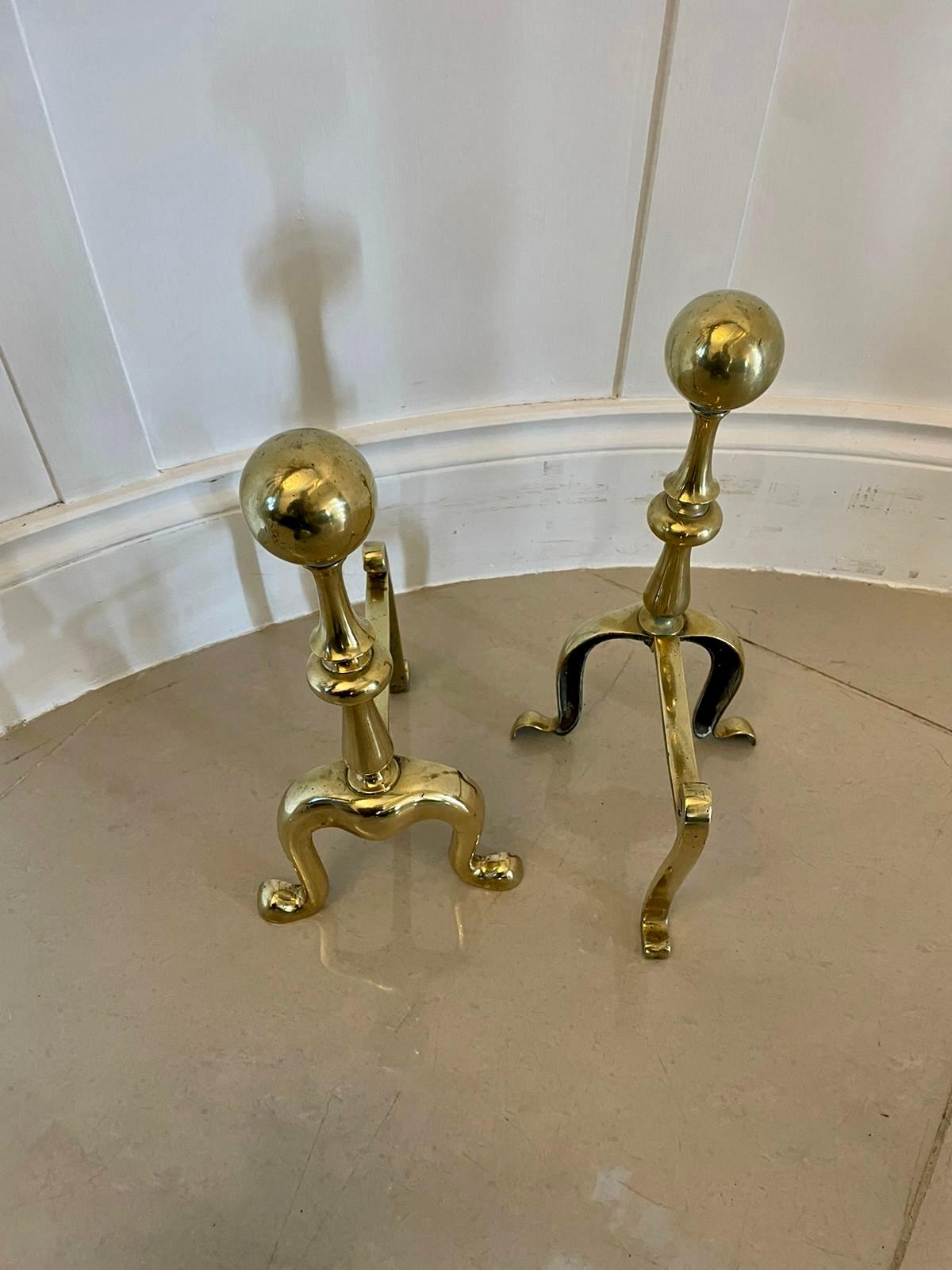Pair of antique Victorian quality brass fire dogs having large quality brass balls supported on turned columns raised on shaped feet united by a brass stretcher. 

In splendid original condition.

Measures: H 34 x W 17 x D 20cm.
Date 1860.
 
