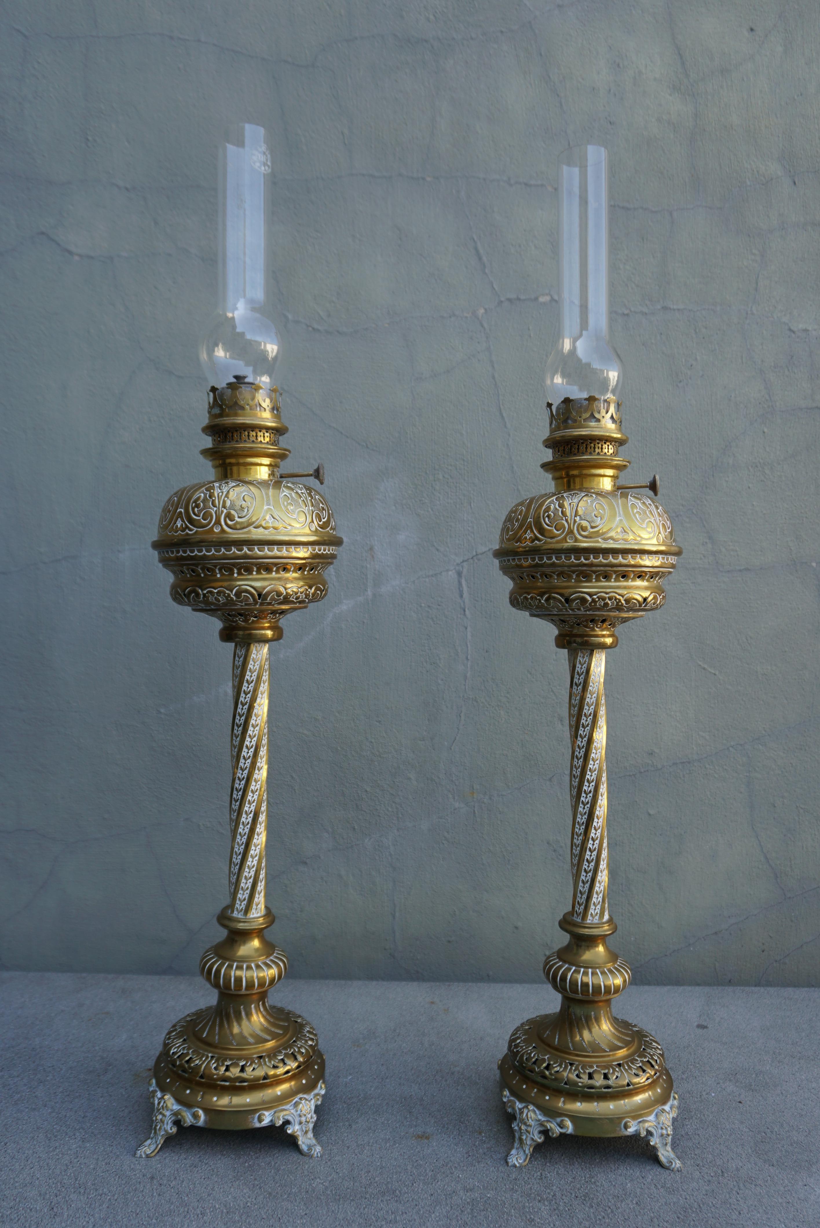 A pair of antique Victorian column brass oil lamps made in Belgium.
Comes with a glass shade.The designer lamp is made in a classic style, the body-capacity of the lamp is made of beautiful handmade brass.There is a stamp on the brass base and on