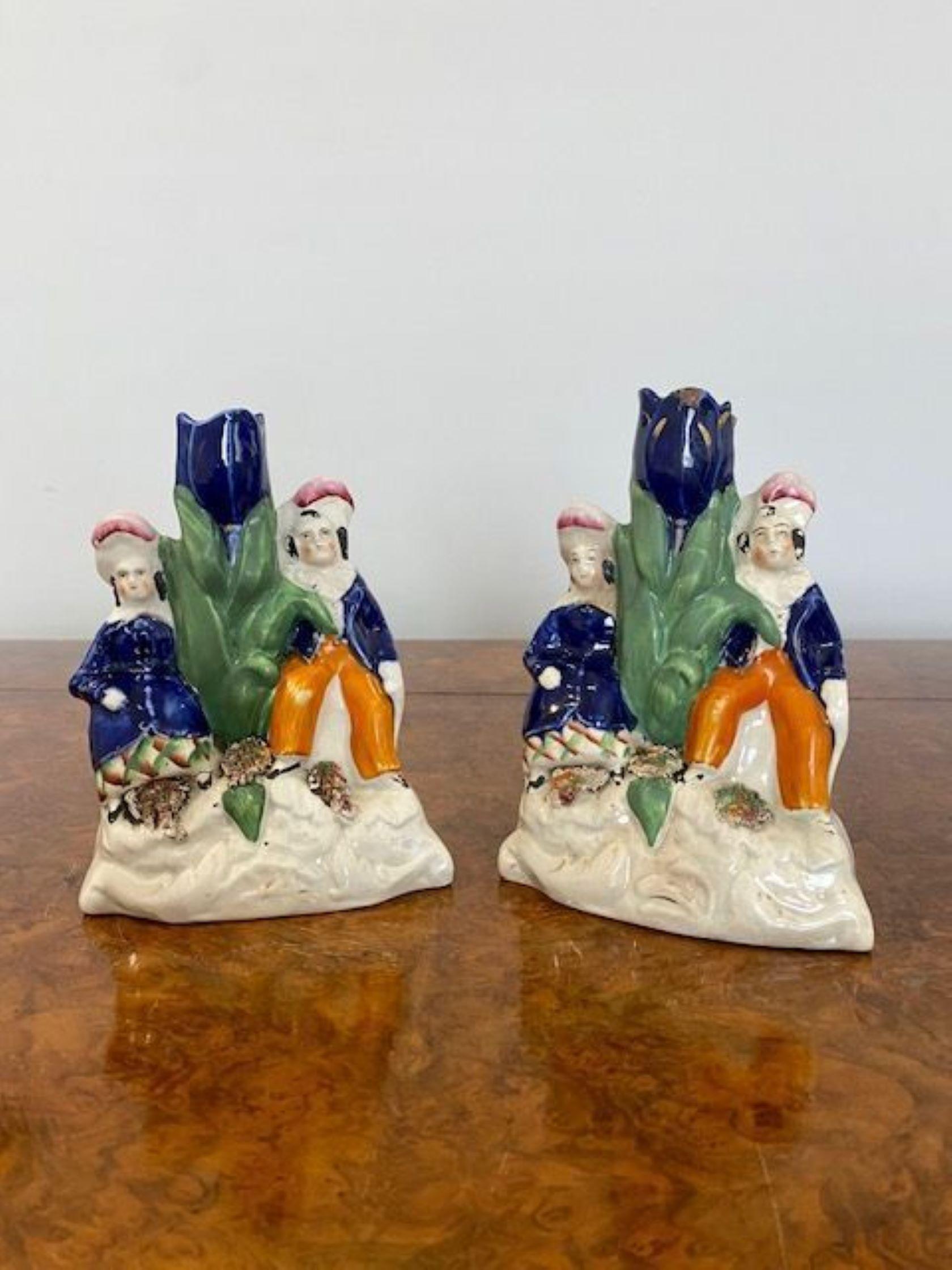Pair of Antique Victorian Staffordshire candle holders with two children sitting next to a candle holder in wonderful blue, orange, green and white colours   