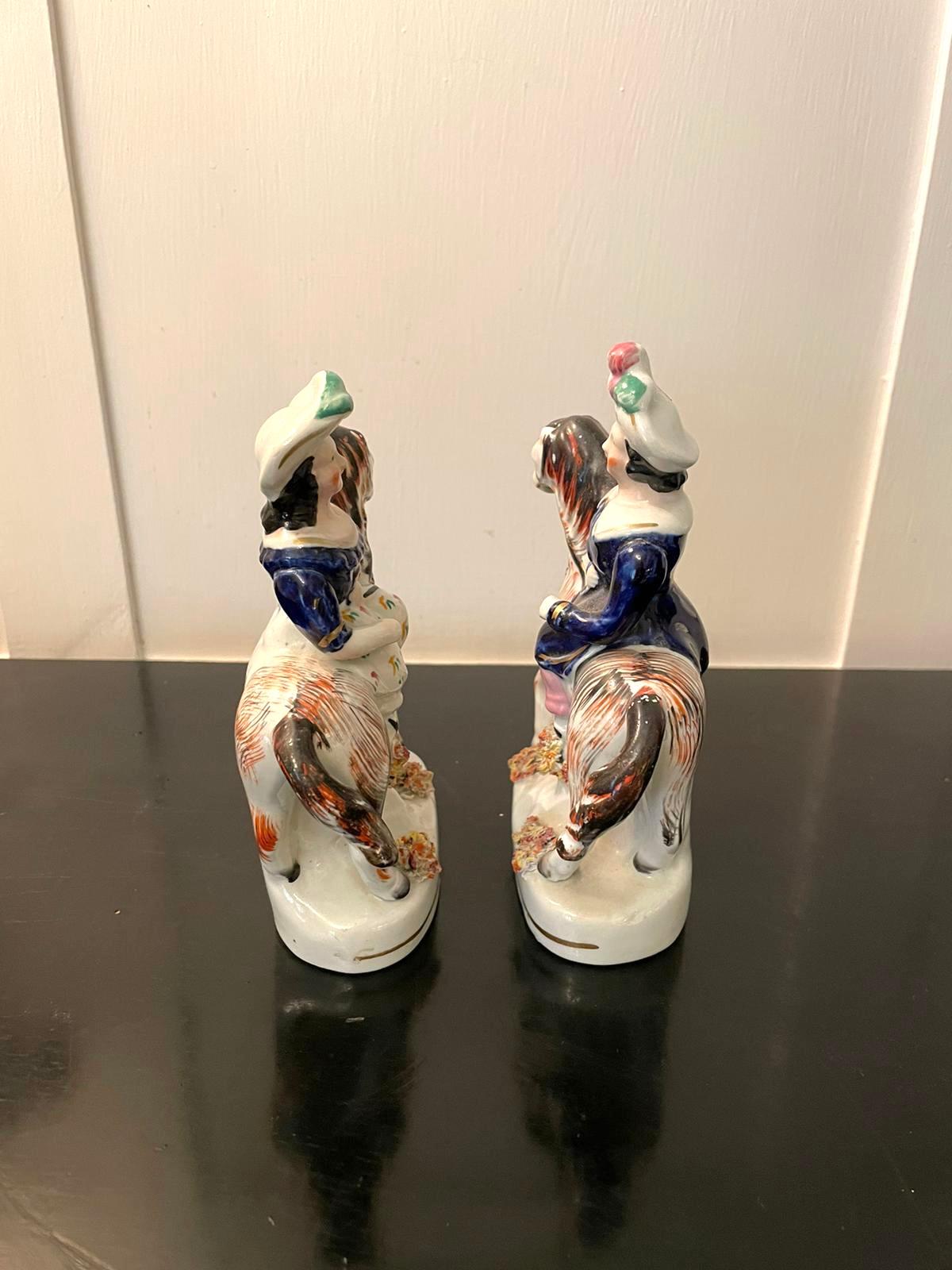 Pair of antique Victorian Staffordshire figures of two ladies in period clothing riding colourful horse’s on oval shaped bases.

In lovely original condition.

Measures: H 15 cm 
W 10 cm 
D 4.5 cm
Date 1880.
 