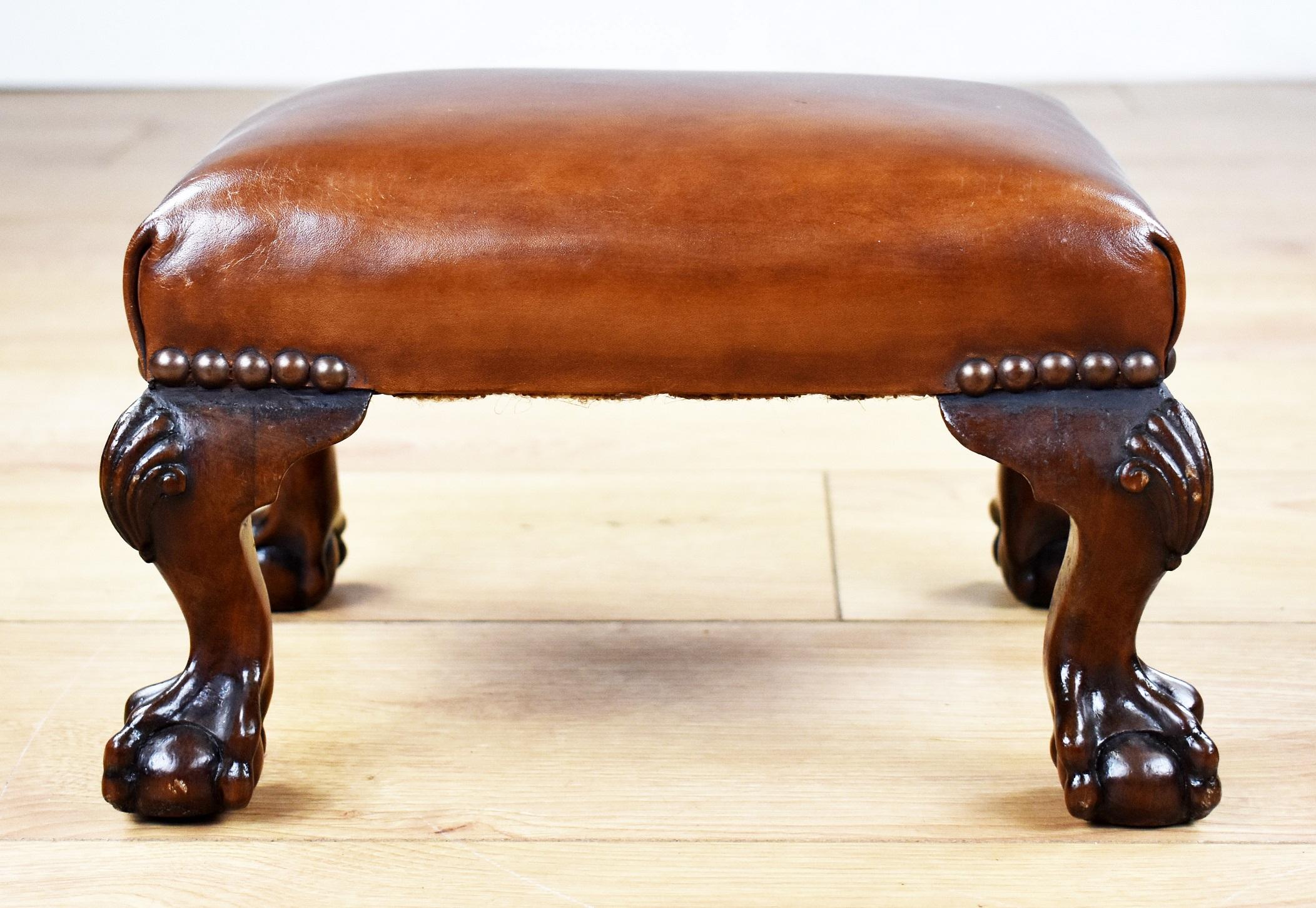 Pair of antique walnut claw and ball hand dyed leather stools in very good condition having been polished by hand and recently leathered.