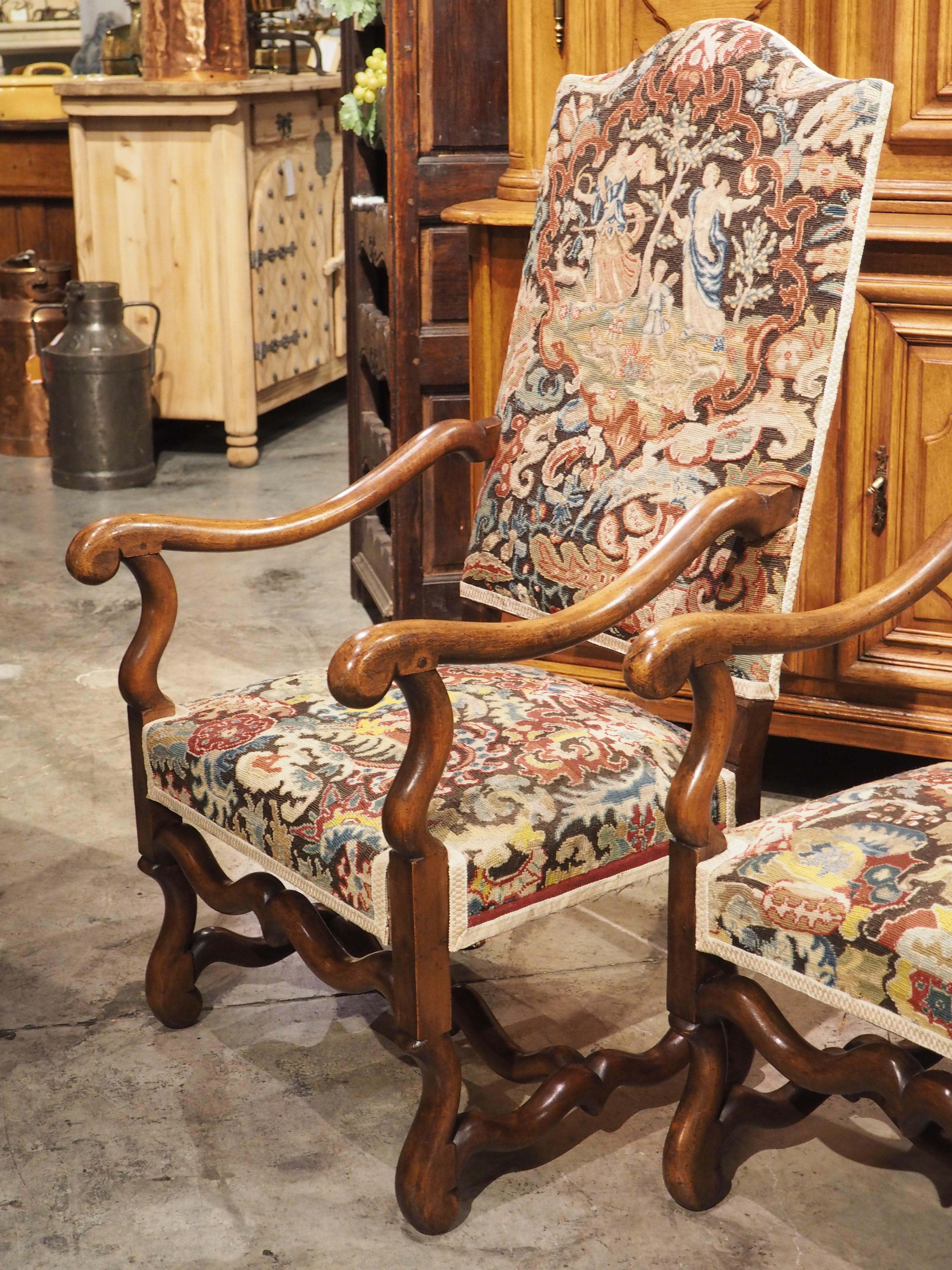 Known as os de mouton (“sheep bone”), this pair of walnut armchairs were hand-carved in France, circa 1880. An H-shaped stretcher is typical of a late Louis XIII/early Louis XIV armchair and the shapely connectors flow seamlessly into the rounded