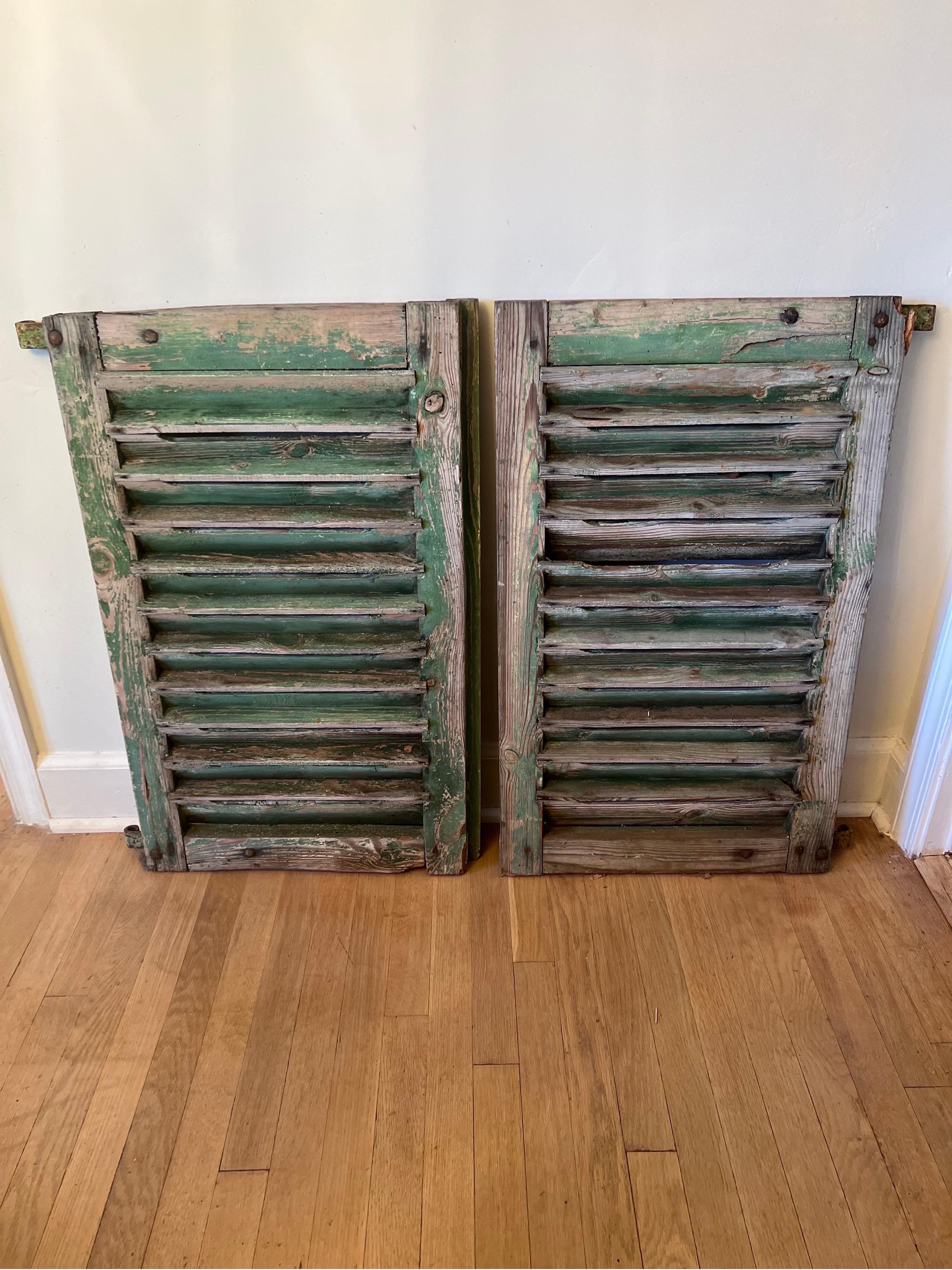 Pair of Antique French wooden shutters.  Original ironwork, chippy paint and wood.  See pics.  