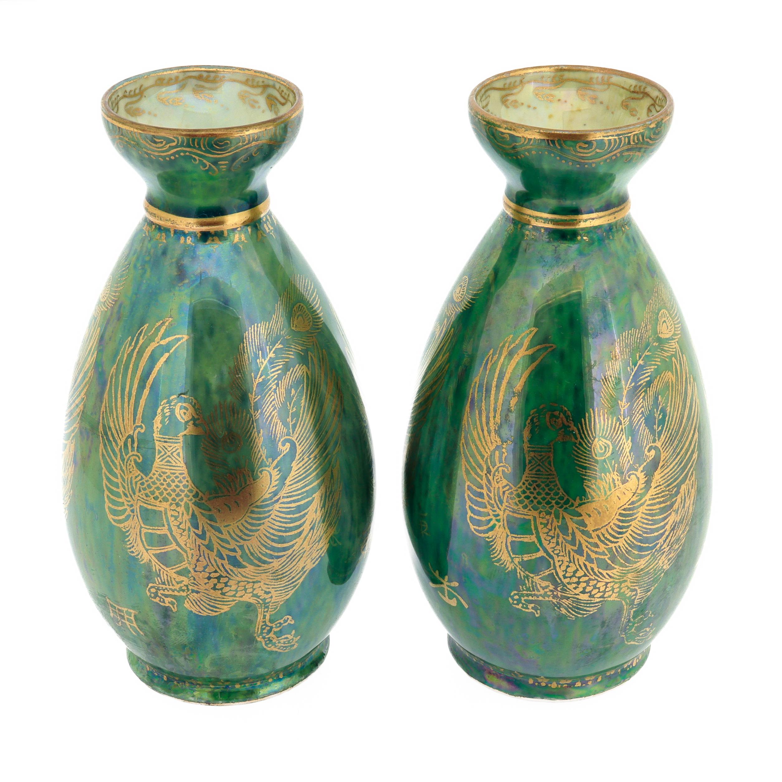 A fine pair of antique English lustreware porcelain vases.

By Wedgwood.

Pattern no. Z4831

Designed by Daisy Makeig-Jones.

Each decorated throughout with gilt phoenix motifs on a lustrous green grounds.

Marked to the base of each.

Susannah