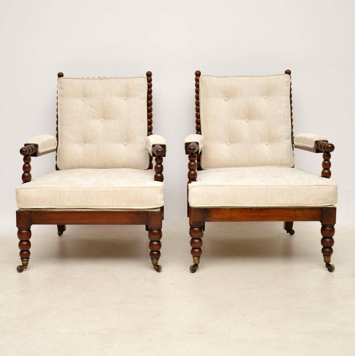 Pair of antique William IV mahogany turned bobbin framed armchairs. The frames are in excellent original condition, sturdy and full of character. The turned bobbin legs sit on original brass capped casters. The cushions are original to the chairs