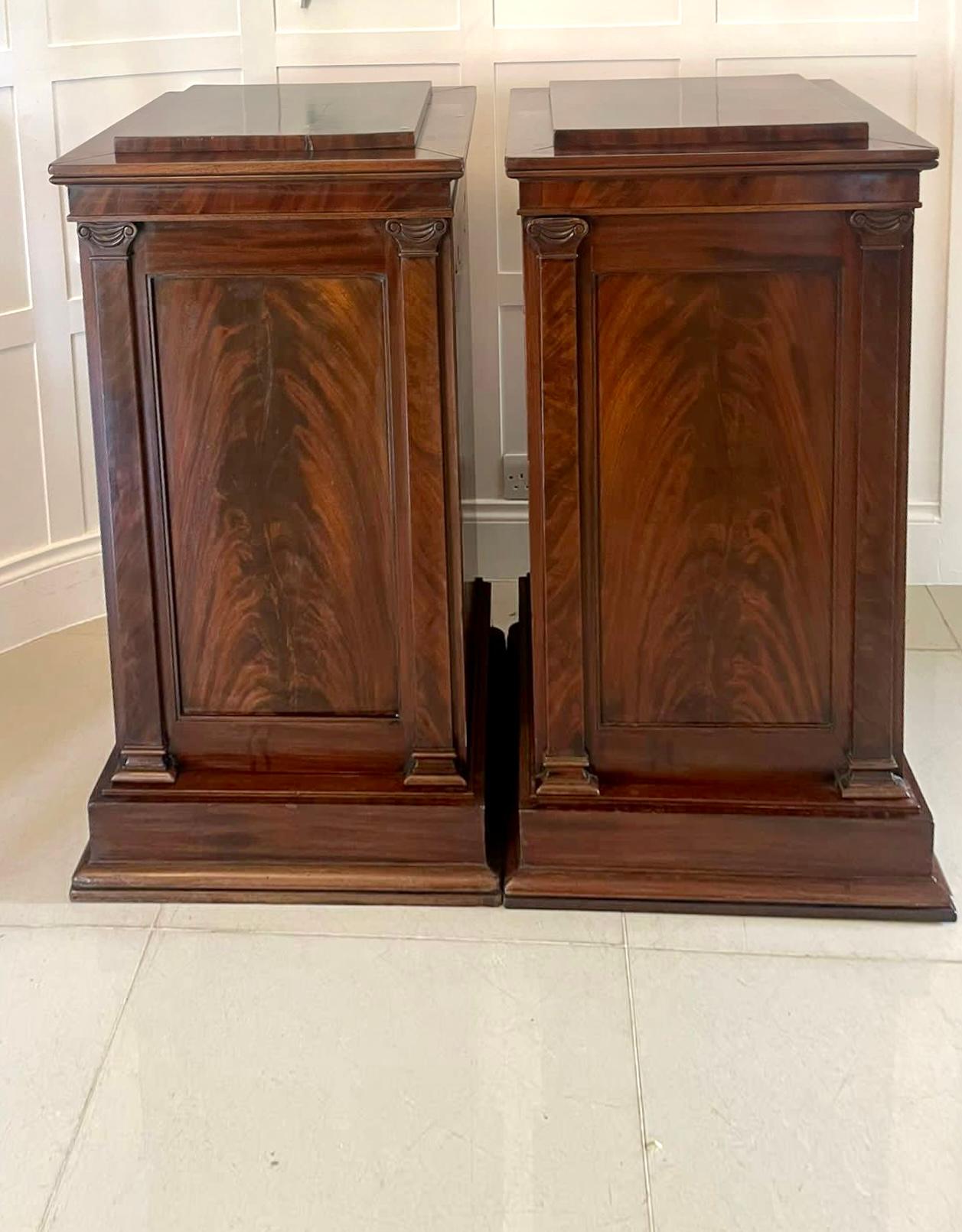Pair of antique William IV quality figured mahogany pedestal cupboards having a quality figured mahogany stepped top above a figured mahogany panelled door opening to reveal a fitted interior consisting of adjustable shelves and a large drawer with