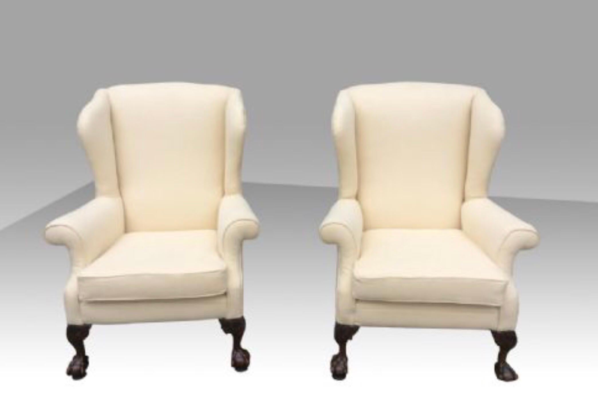 Superb pair of antique wing back Wingback arm chairs with mahogany ball and claw feet,beautifully and expertly re upholstered in a lovely cream wearable material.
The chairs sit on swivel Bakelite glides for ease of movement and to prevent damage