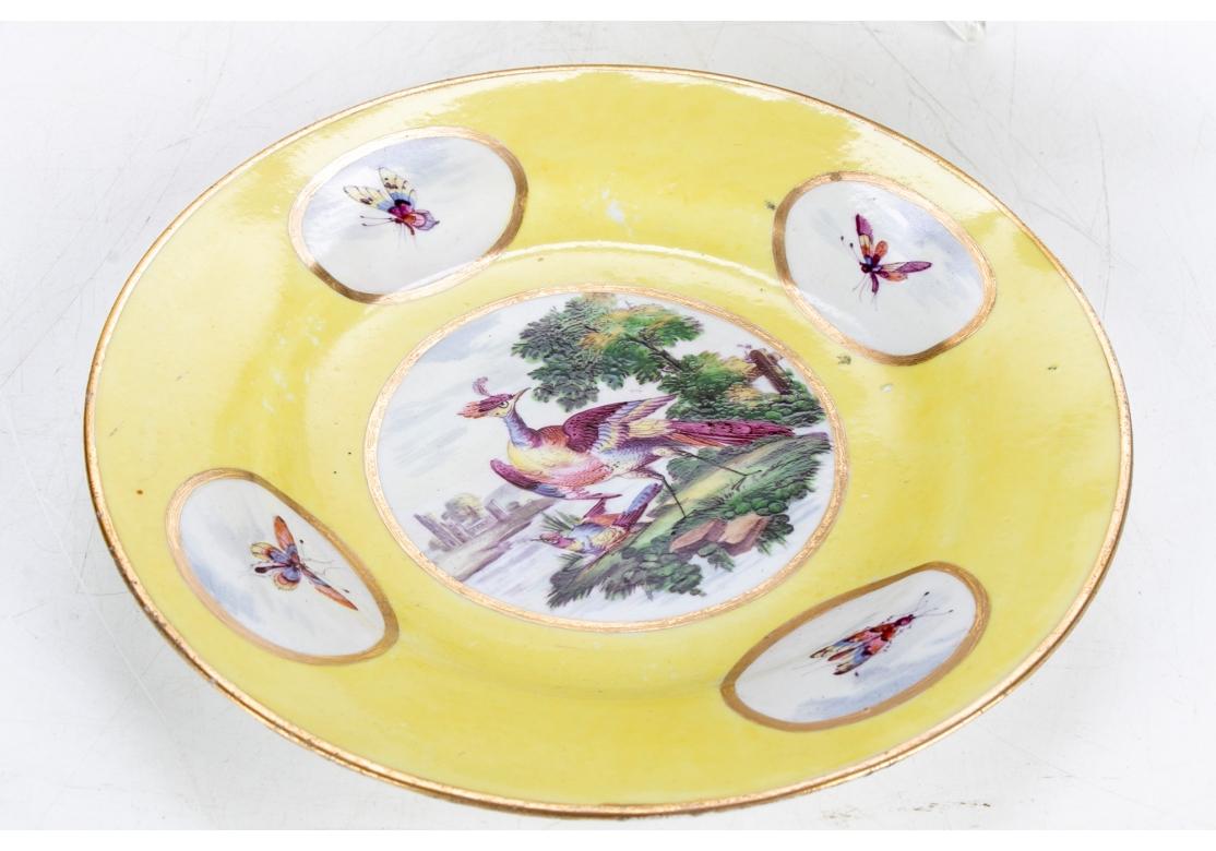 Pair of yellow dessert plates with exotic bird medallions and butterfly cameos. Impressed crown mark on verso.
Retains antique shop stickers on verso with retail price of $2500. circa 1792 - 1807.
Dimensions: 8 1/4