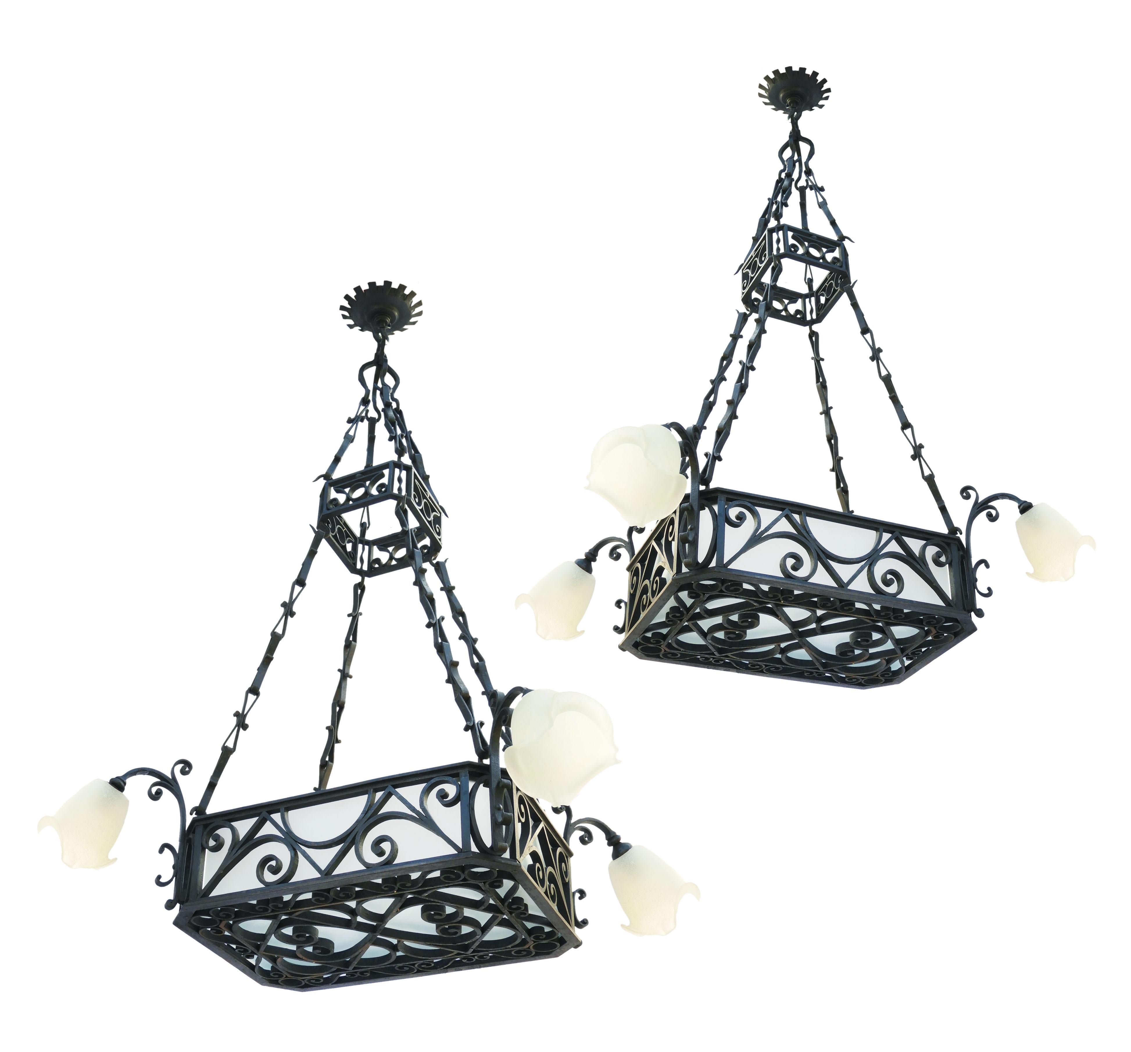 Large French wrought iron and frosted glass chandeliers, circa 1900. A stunning rare find. These originally came from a restaurant in Biarritz, popular during the Belle Époque era. These heavy, Artisan made chandeliers each have a central basket