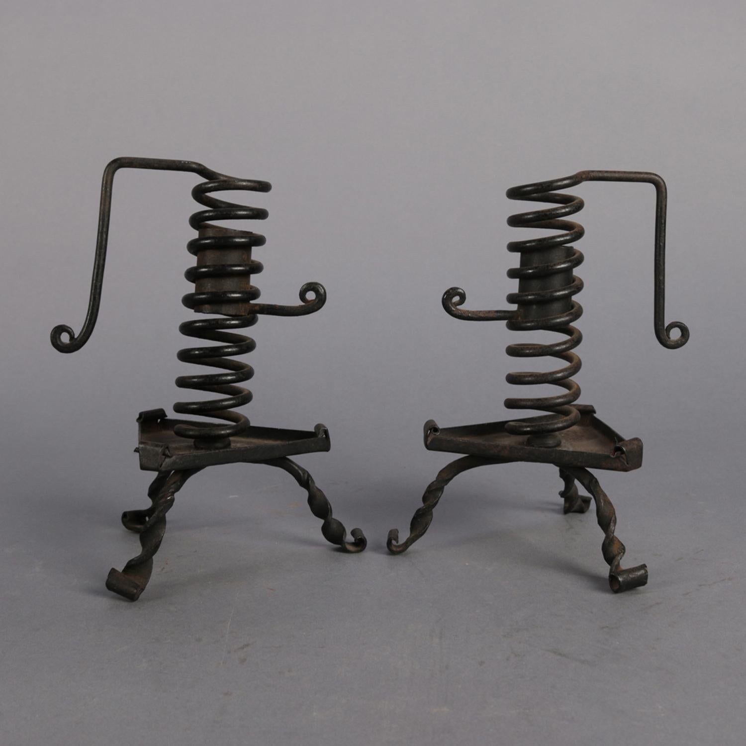 Pair of antique hand held courting candle sticks feature spiral and footed wrought iron construction with scrolled handles and height adjusters, circa 1830

Measures: 7
