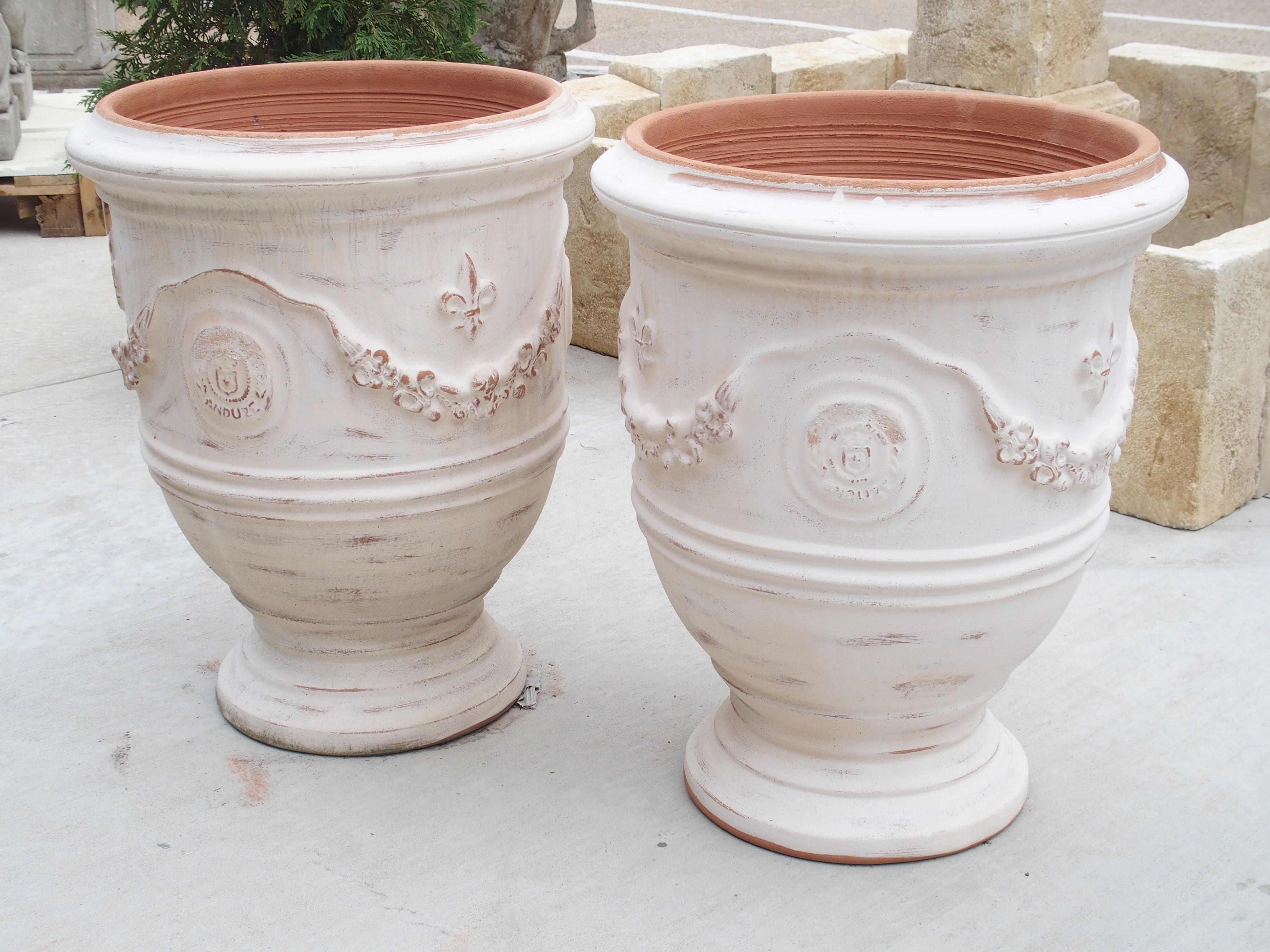 Terracotta Pair of Antiqued White Fleur-de-Lys Anduze Pots from France