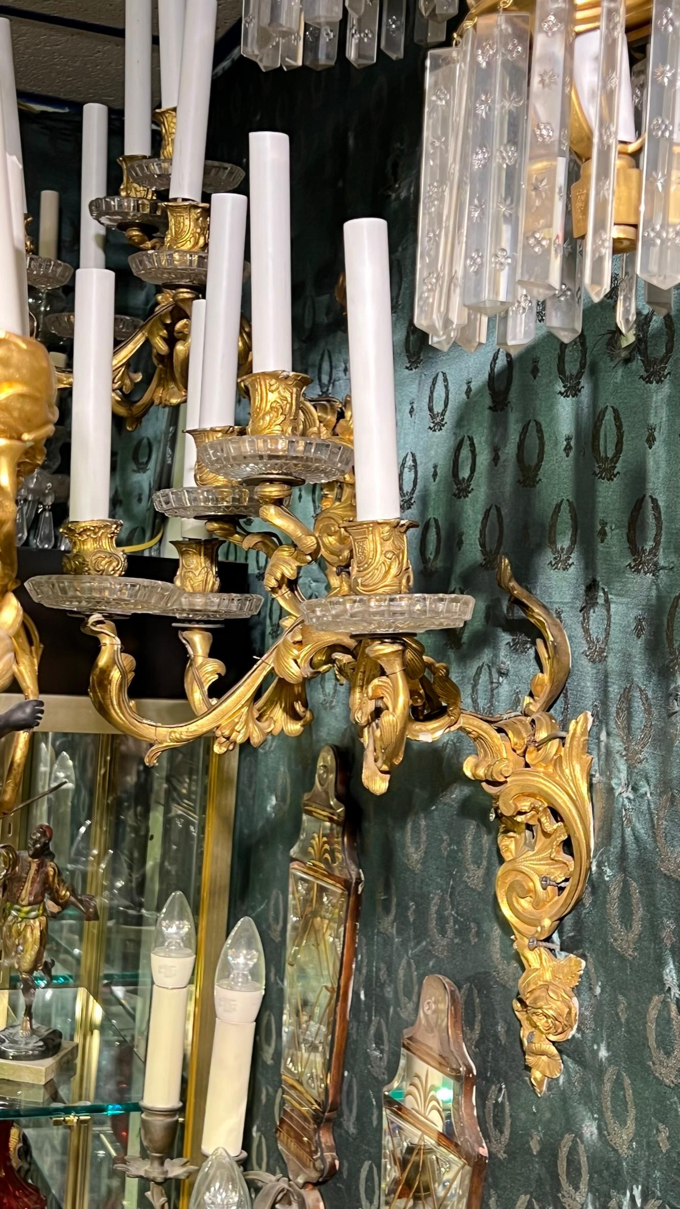 Pair of Antique French Five-Arm Gilt Bronze and Crystal Wall Light Sconces in the Louis XV Style.  With candelabra size sockets, relatively new plastic candle covers and wiring, ready for installation.