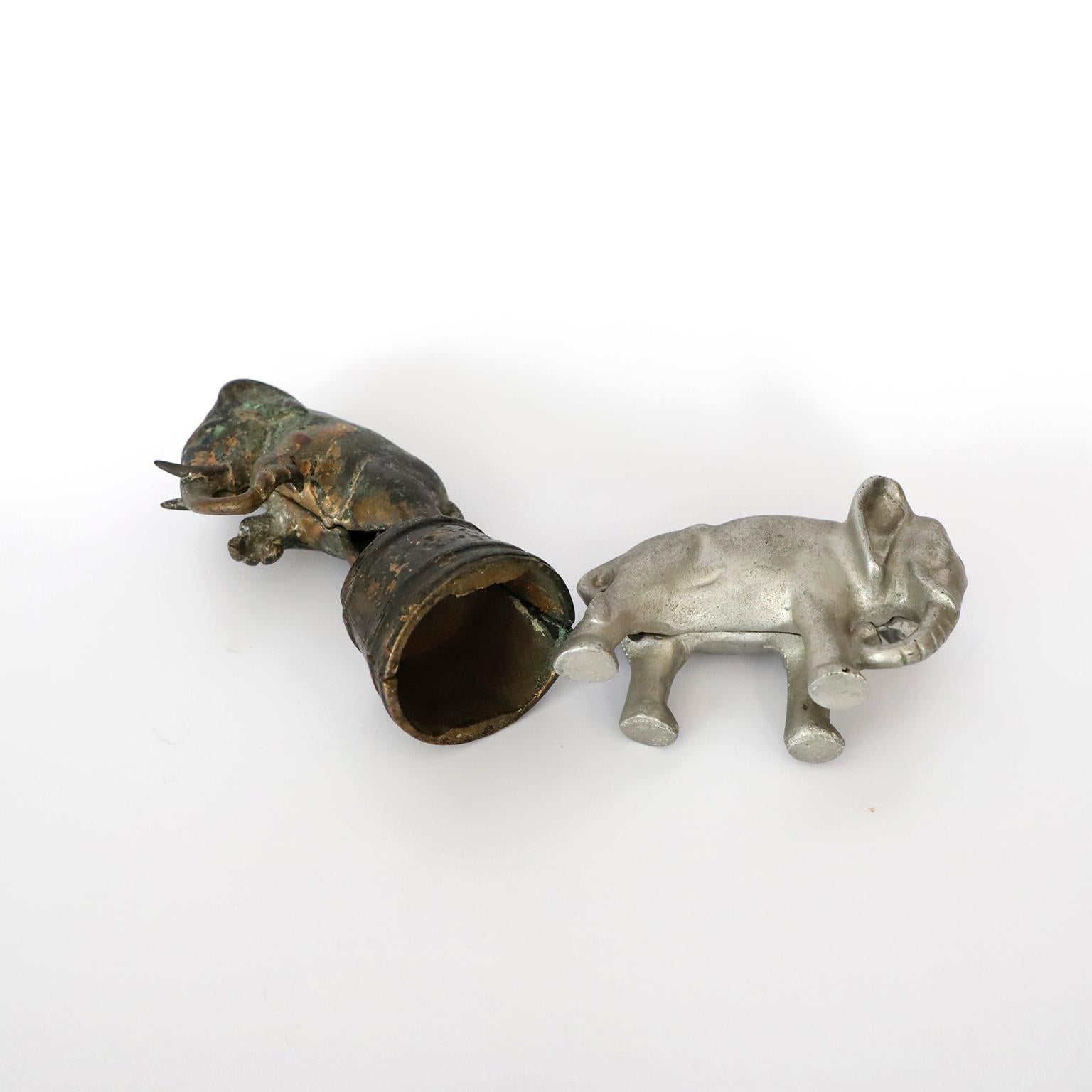 Pair of Antiques money box / bank, elephants.

One of them circa 1920, made in iron, the other circa 1960 made in aluminium.
 