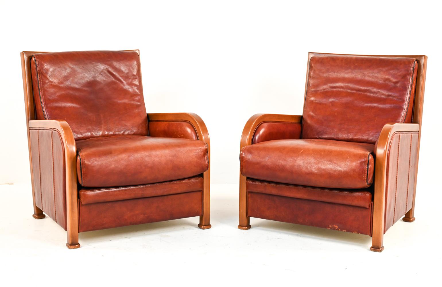These rare Danish midcentury Anton Dam club chairs have a great Art Deco style. These chairs combine round and straight lines in an attractive way. With wooden frames and red leather upholstery, these chairs make an eye catching statement and will