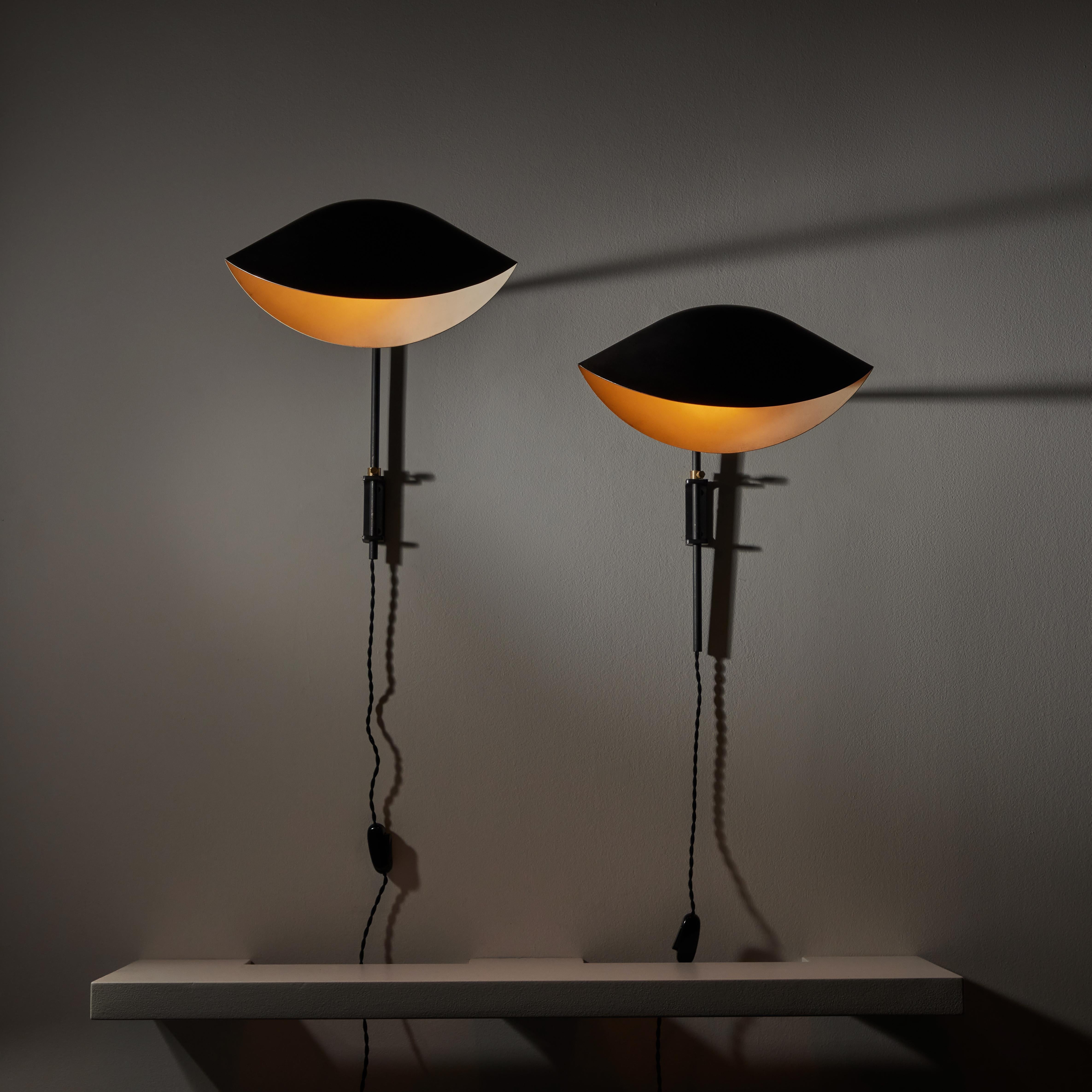 Pair of Antony Sconces by Serge Mouille. Manufactured in France, circa the 1970s. Wall mounted black enameled steel and aluminum sconces with timeless delicate and curved shade. Each lamp holds one bayonet bulb socket. We recommend using a 40w