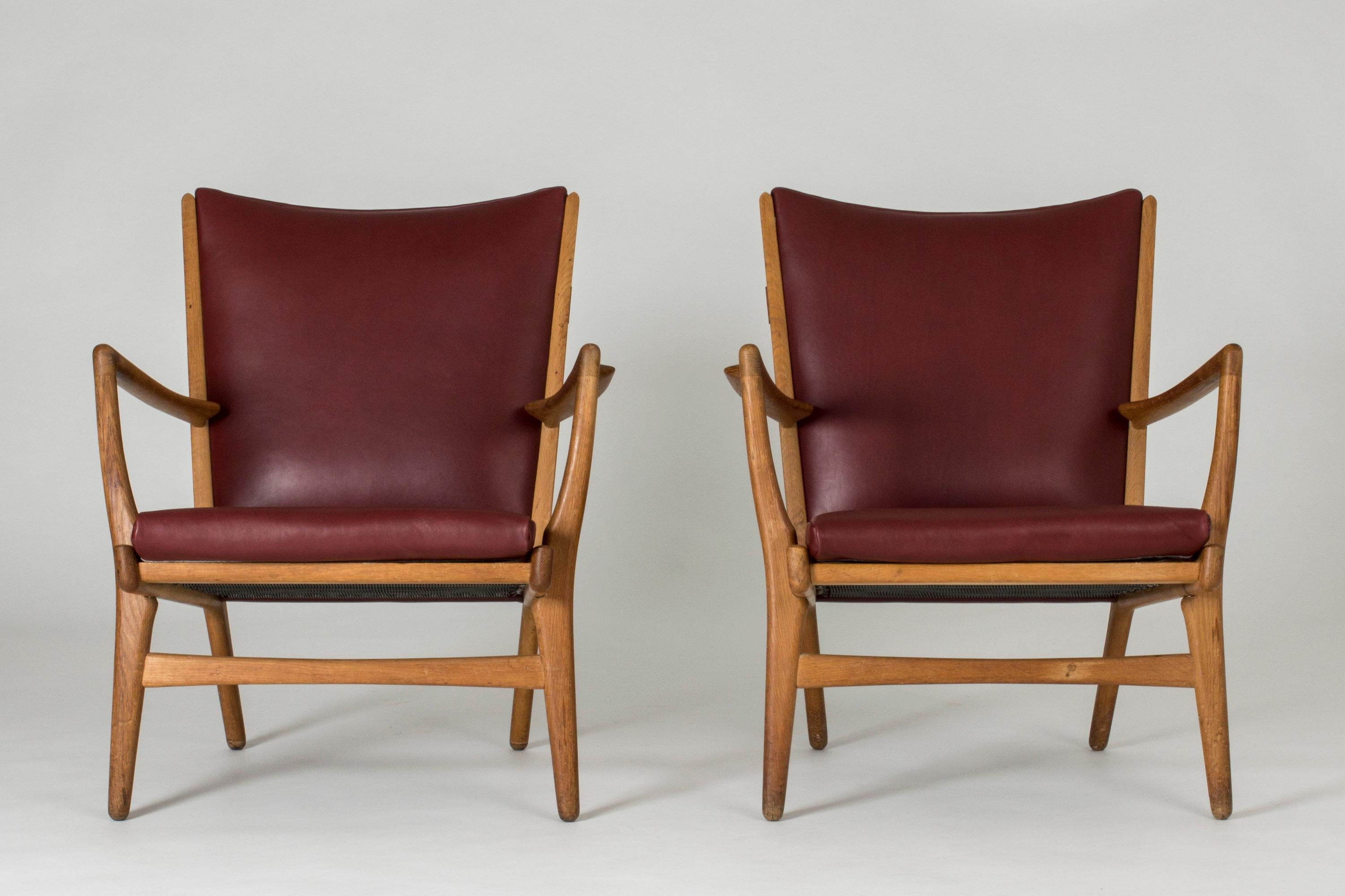 Pair of awesome “AP 16” lounge chairs by Hans J. Wegner. Made from oak and upholstered with beautiful oxblood leather.