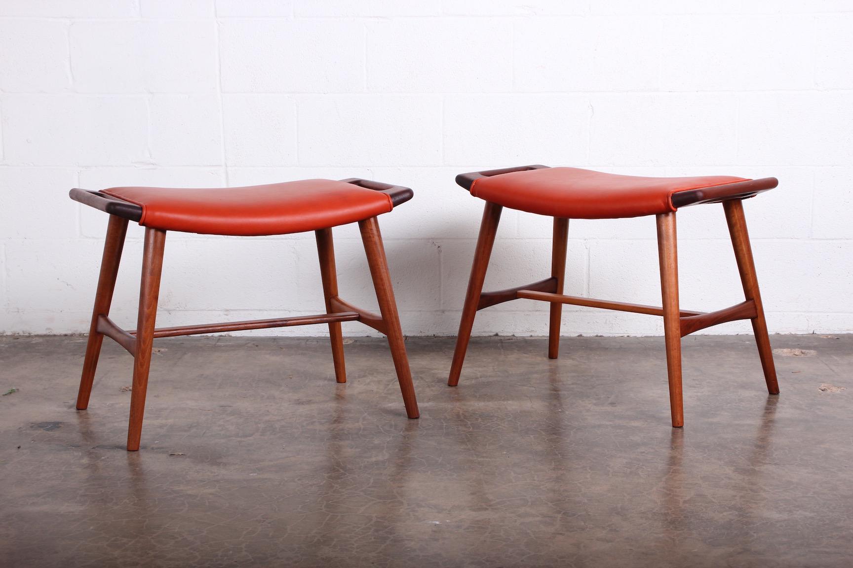 A pair of teak and leather AP-30 stools designed by Hans Wegner for AP-Stolen.