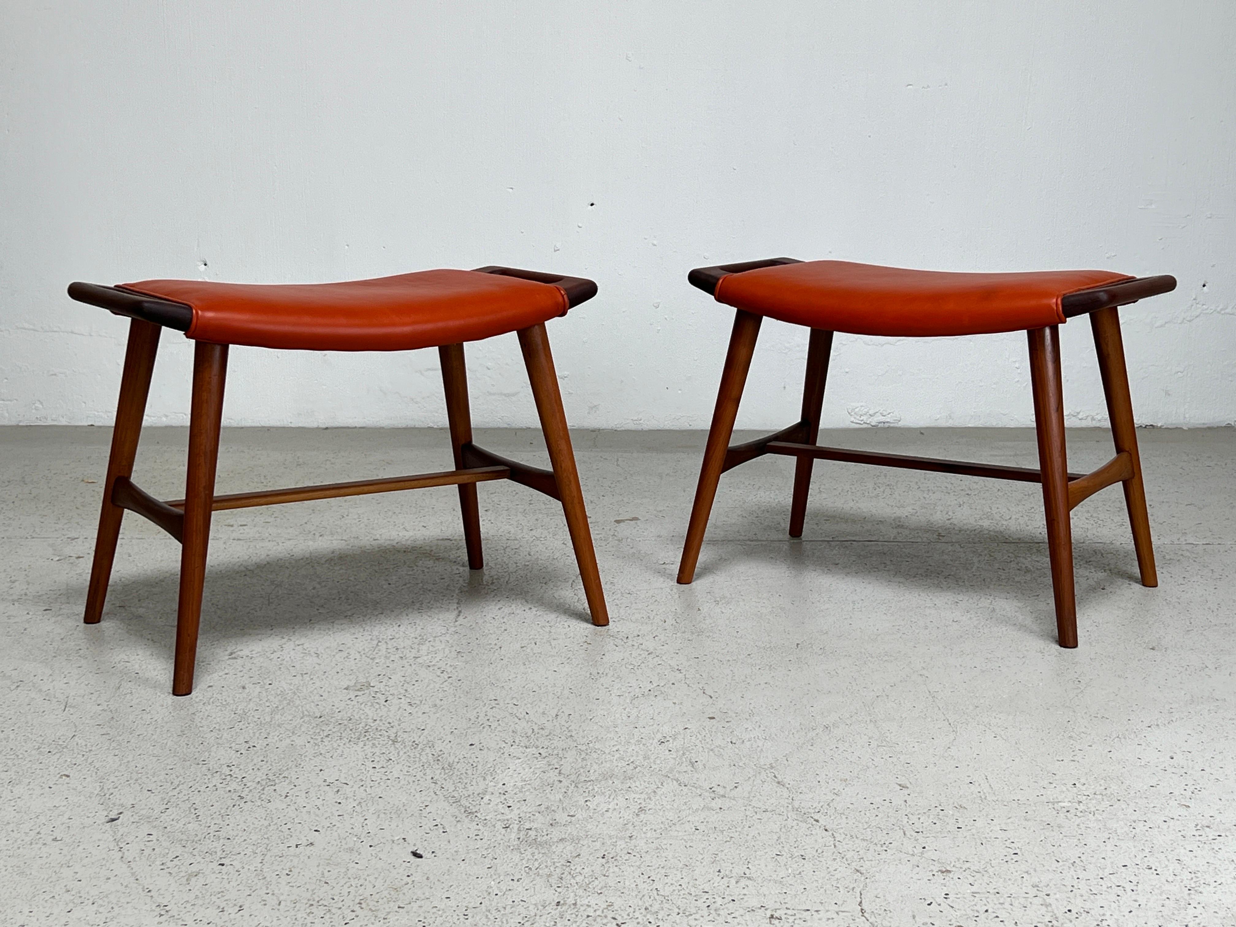 A pair of teak and leather AP-30 stools designed by Hans Wegner for AP-Stolen.