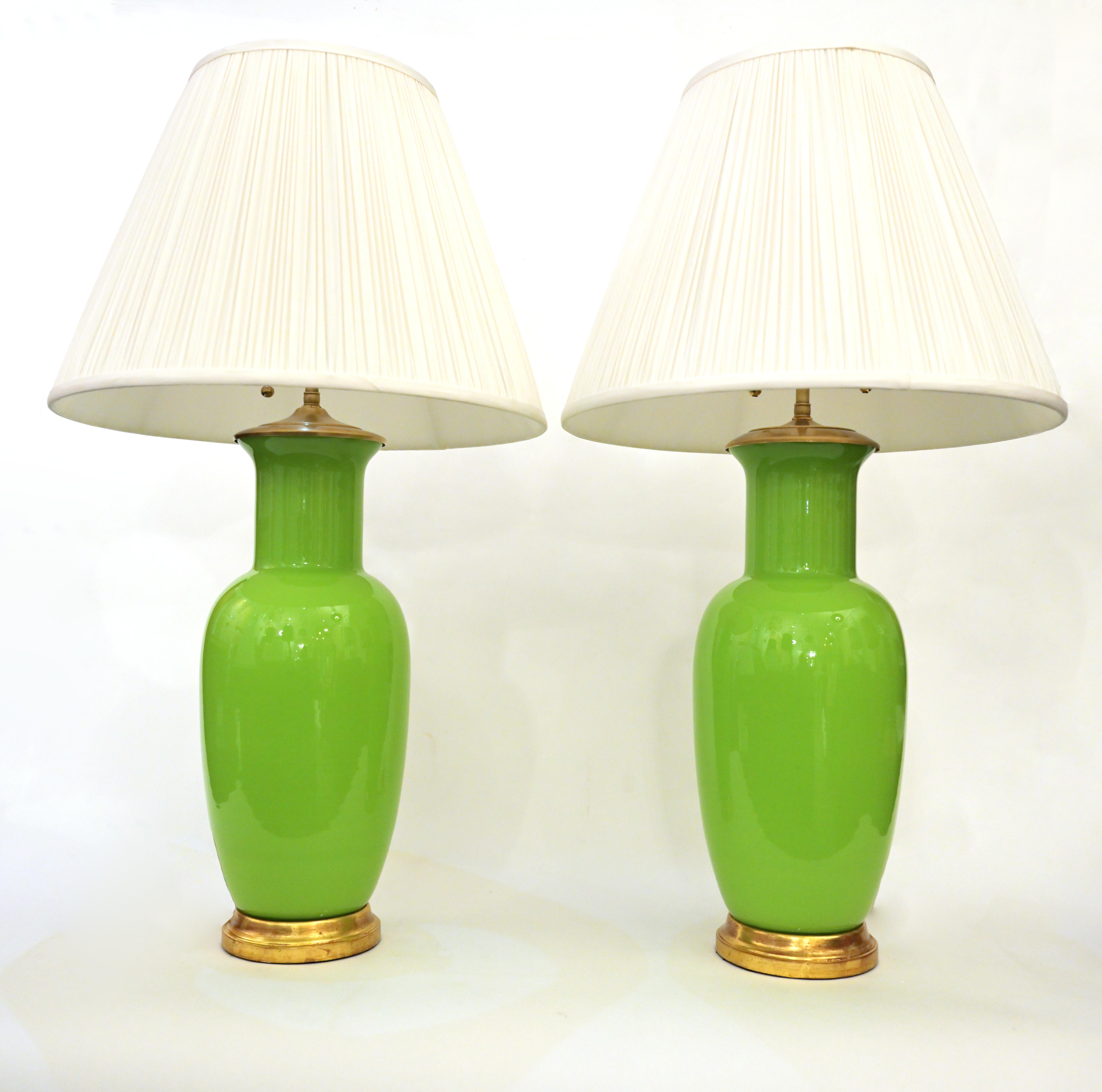 A pair of table lamps made from vintage Murano Glass having gilt wood bases and brass finials with adjustable double cluster, each sockets with 60 watts maximum. Shades are not included.

Center Diameter: 7