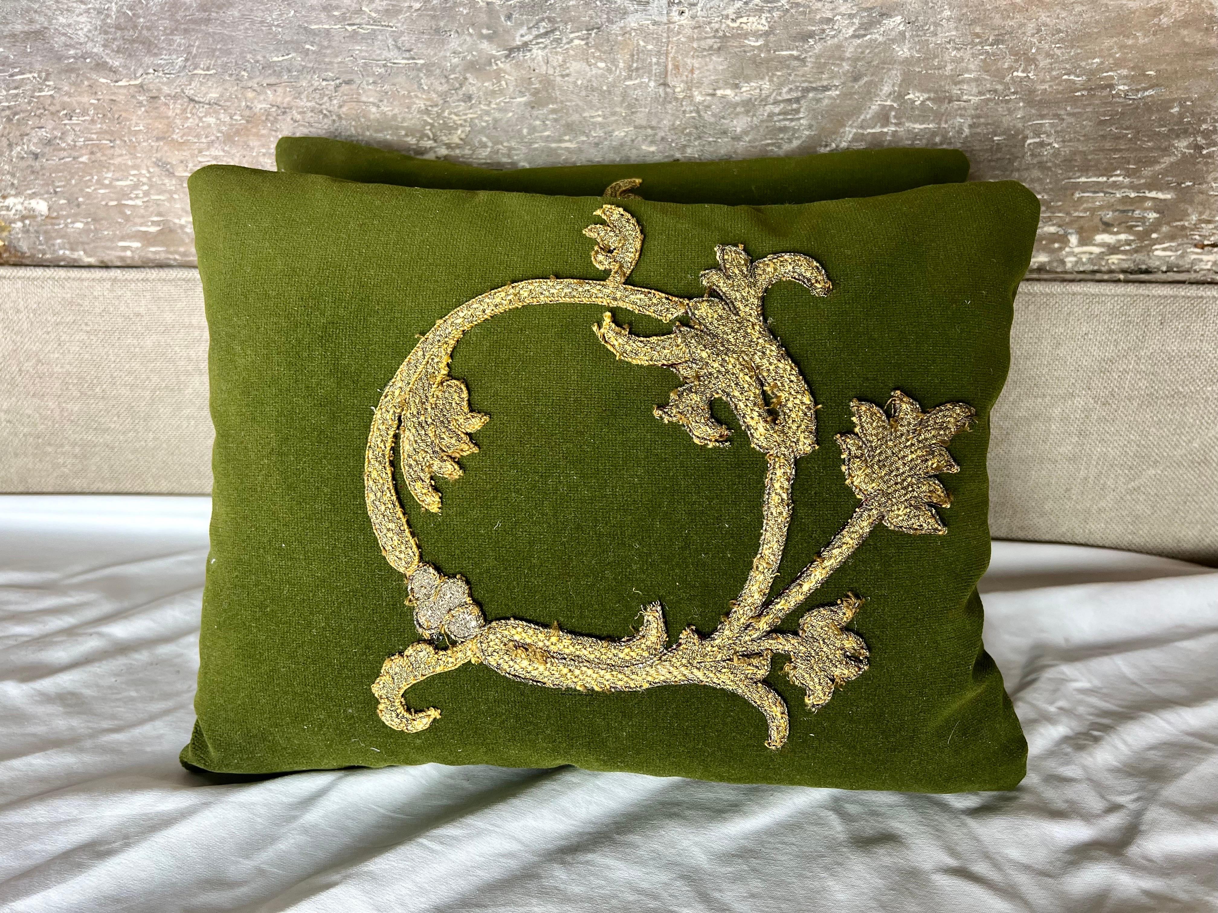 Pair of custom pillows made with 19th century metallic applique sewn on an olive green velvet backround.  Dark gray silk backs with zipper closures.