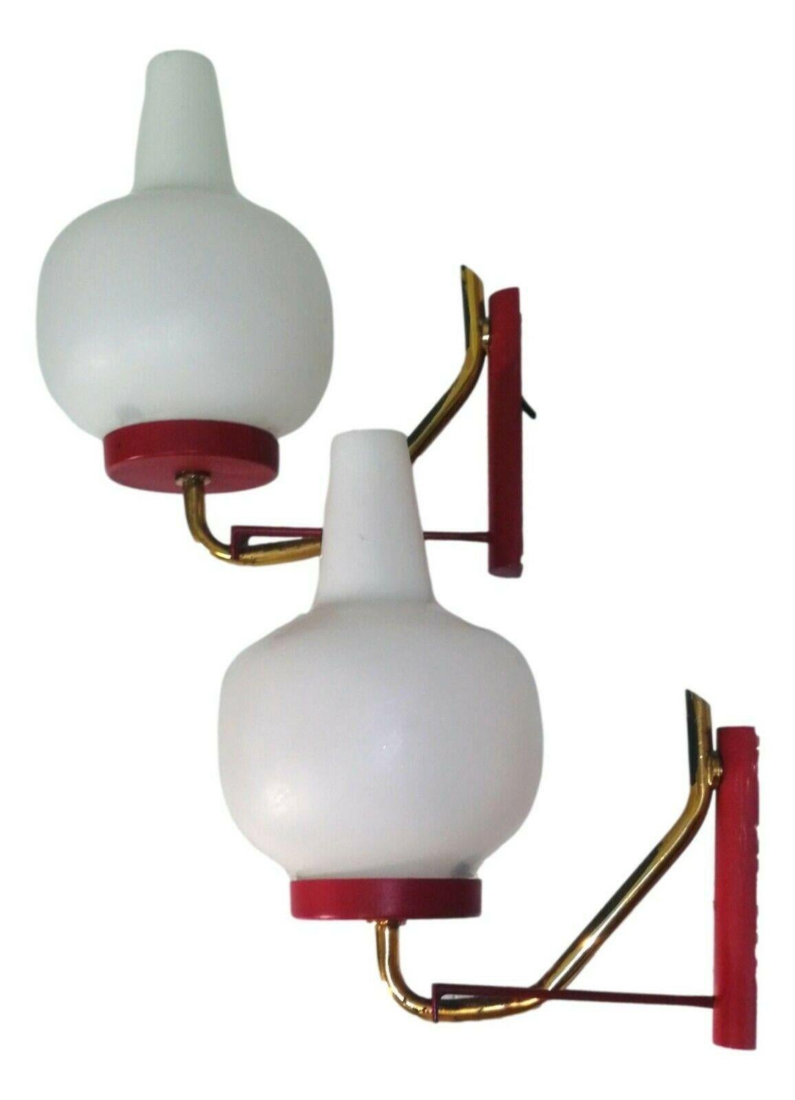 pair of original 60s wall lamps, probably produced by Stilnovo or Arredoluce, made of red lacquered metal with brass elements and blown murano diffusers 

They each measure 20 cm in height and a little less than 20 cm protrusion from the wall, in