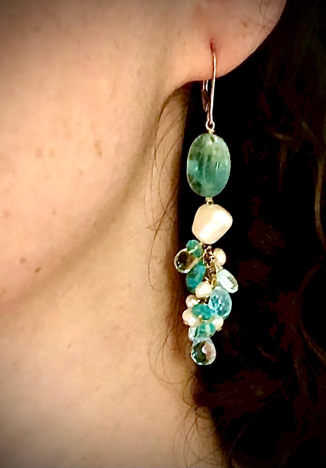 Pair of aquamarine earrings. Large tumbled aquamarines, smooth and faceted aquamarines briolettes, blue topaz briolettes. White freshwater pearls and 14kt white gold.