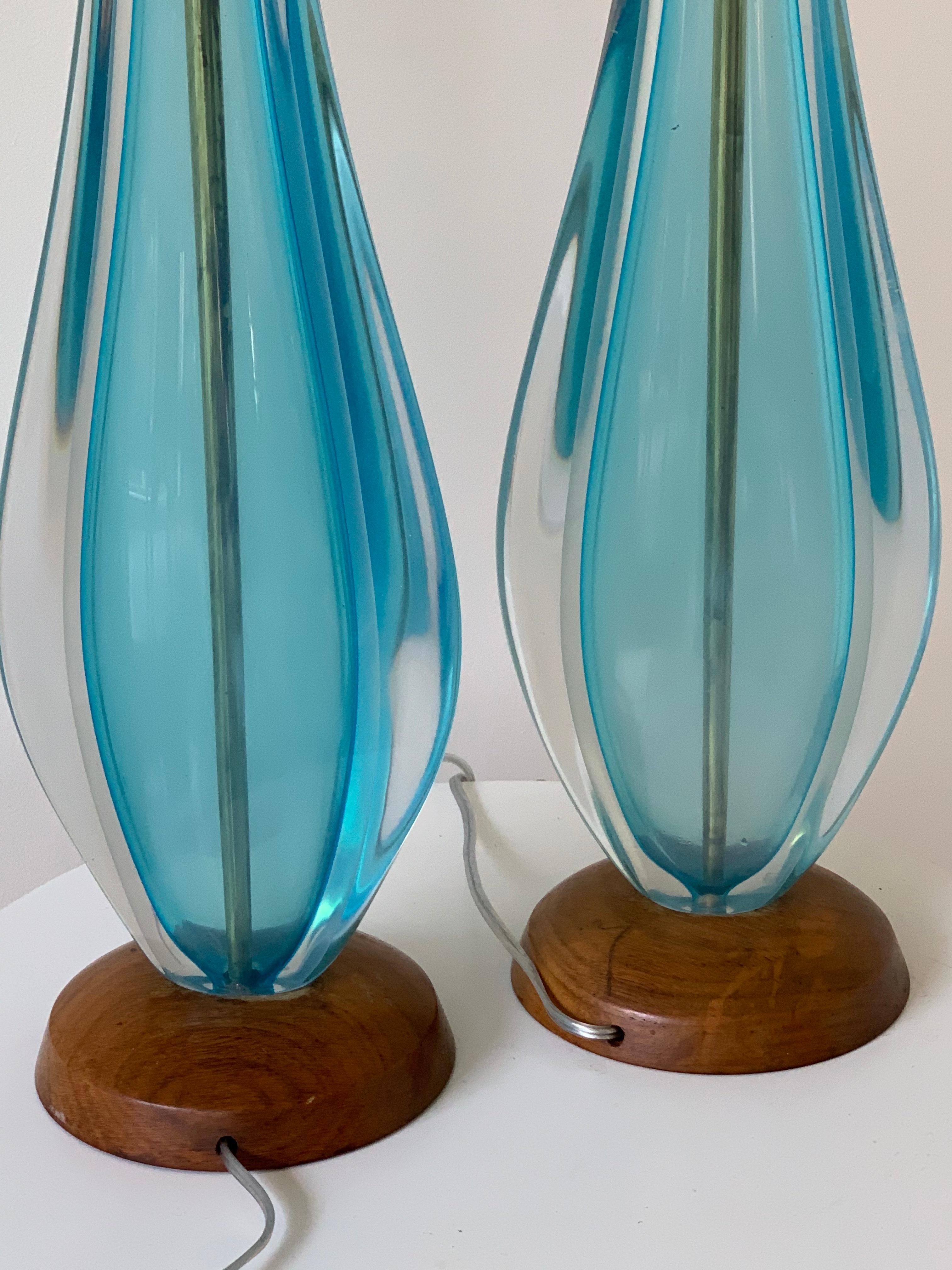 Ethereal blue Murano glass table lamps, set on walnut bases.