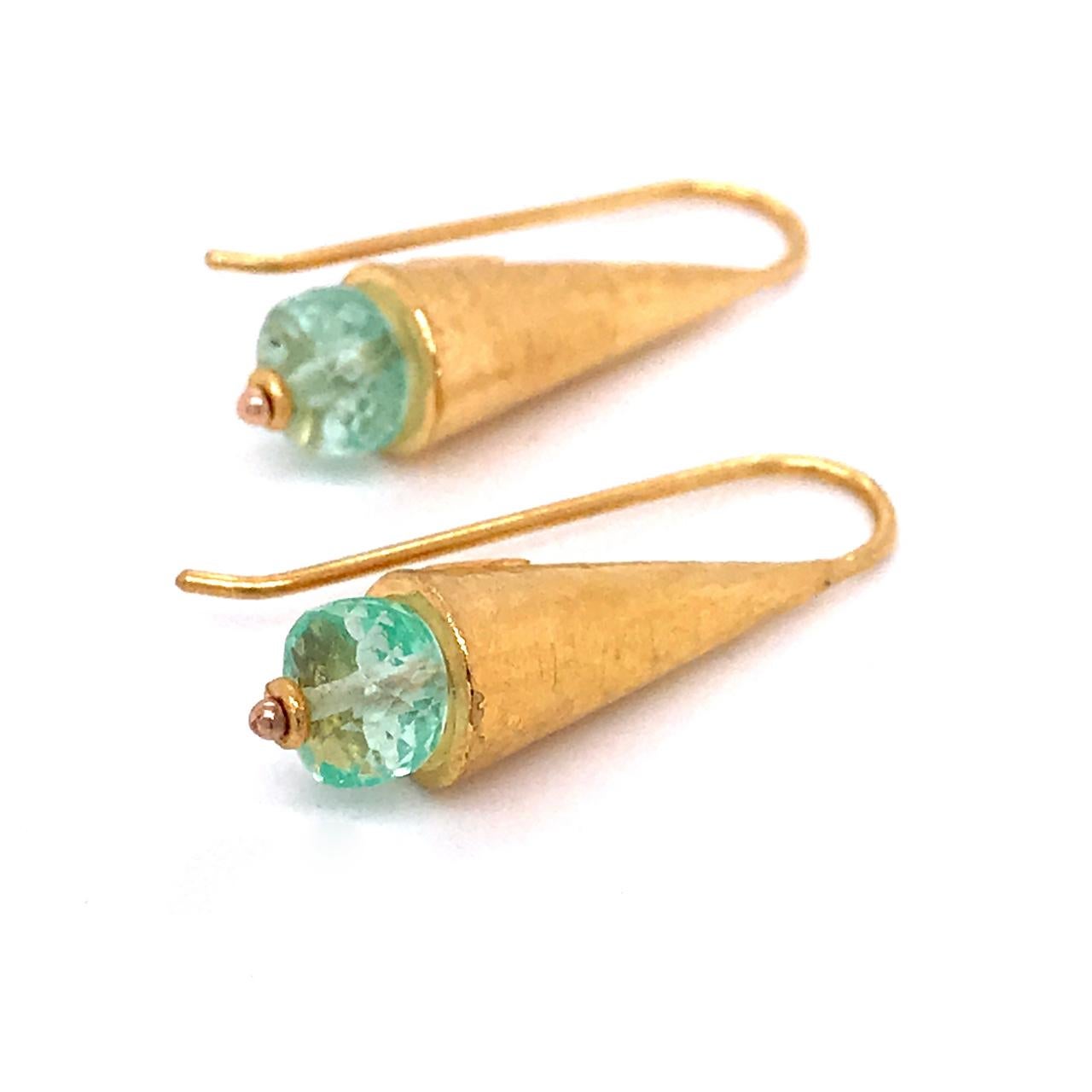 A very fine pair of high-karat gold and emerald ARA earrings.

With a wonderful Egyptian Revival or Ancient Mediterranean feel, the earrings consist of cone-shaped hand-hammered drops mounted with faceted rondelle-cut emerald beads.   

Marked ARA