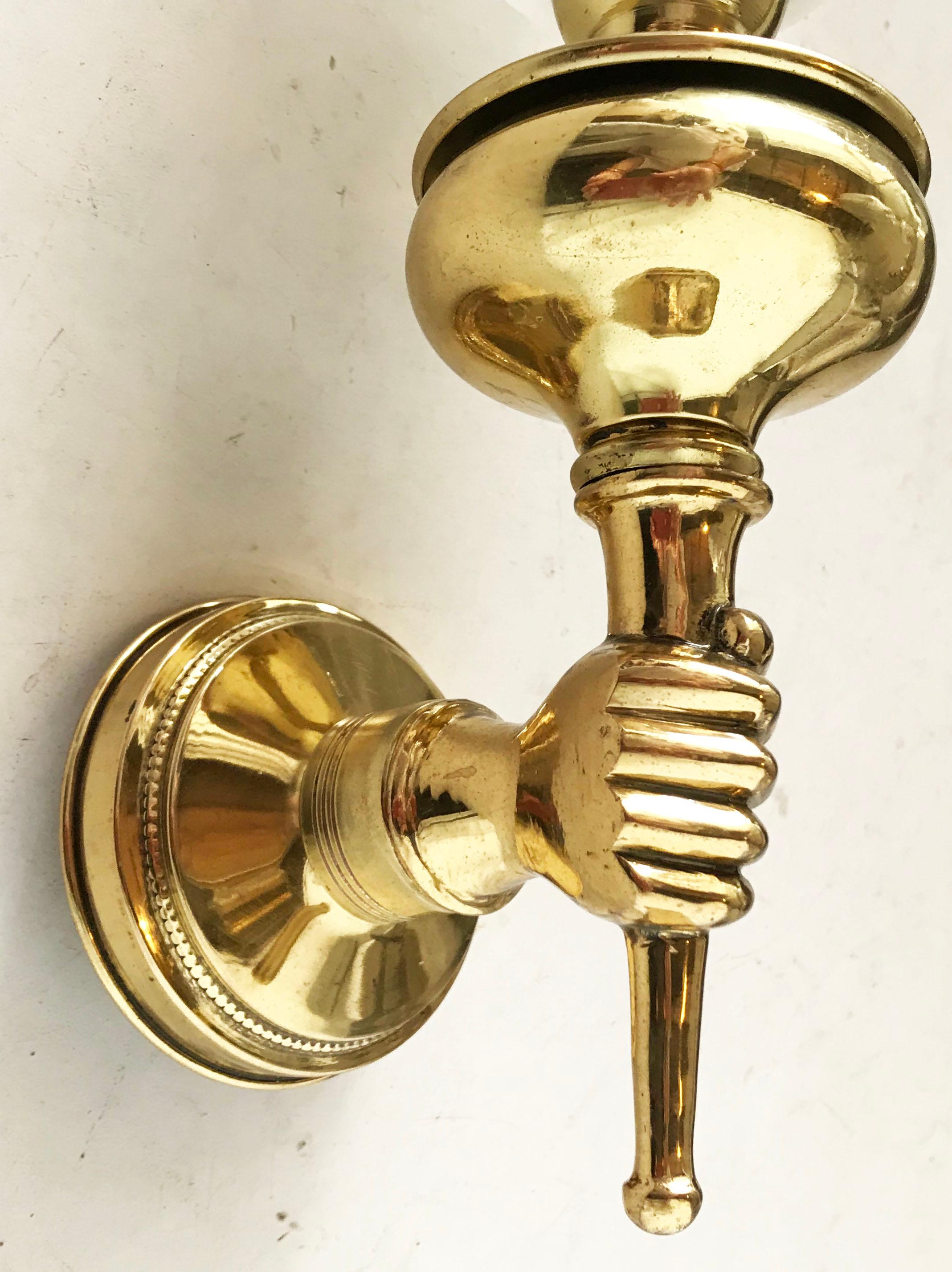 Pair of very elegant hand holding torchiere Arbus sconces.
Brass and white opaline shades
2 Pairs available, priced by pair 
Maximum wattage: 60w/ each bulb
US wired and in working condition.
