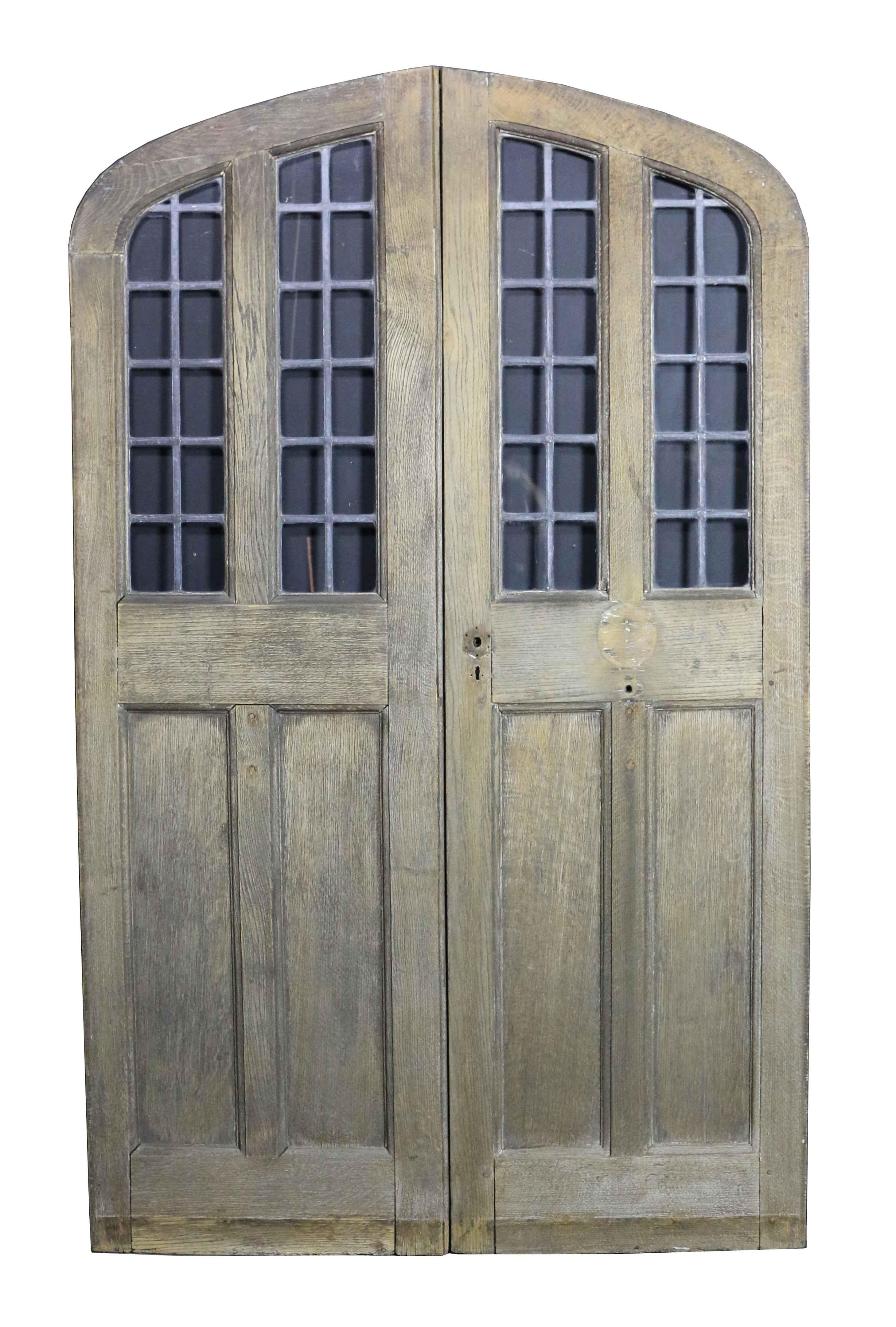 Pair of arched oak double doors with leaded glass panel, circa 1900. Please note that the glass is not insured in transit outside of the UK.
