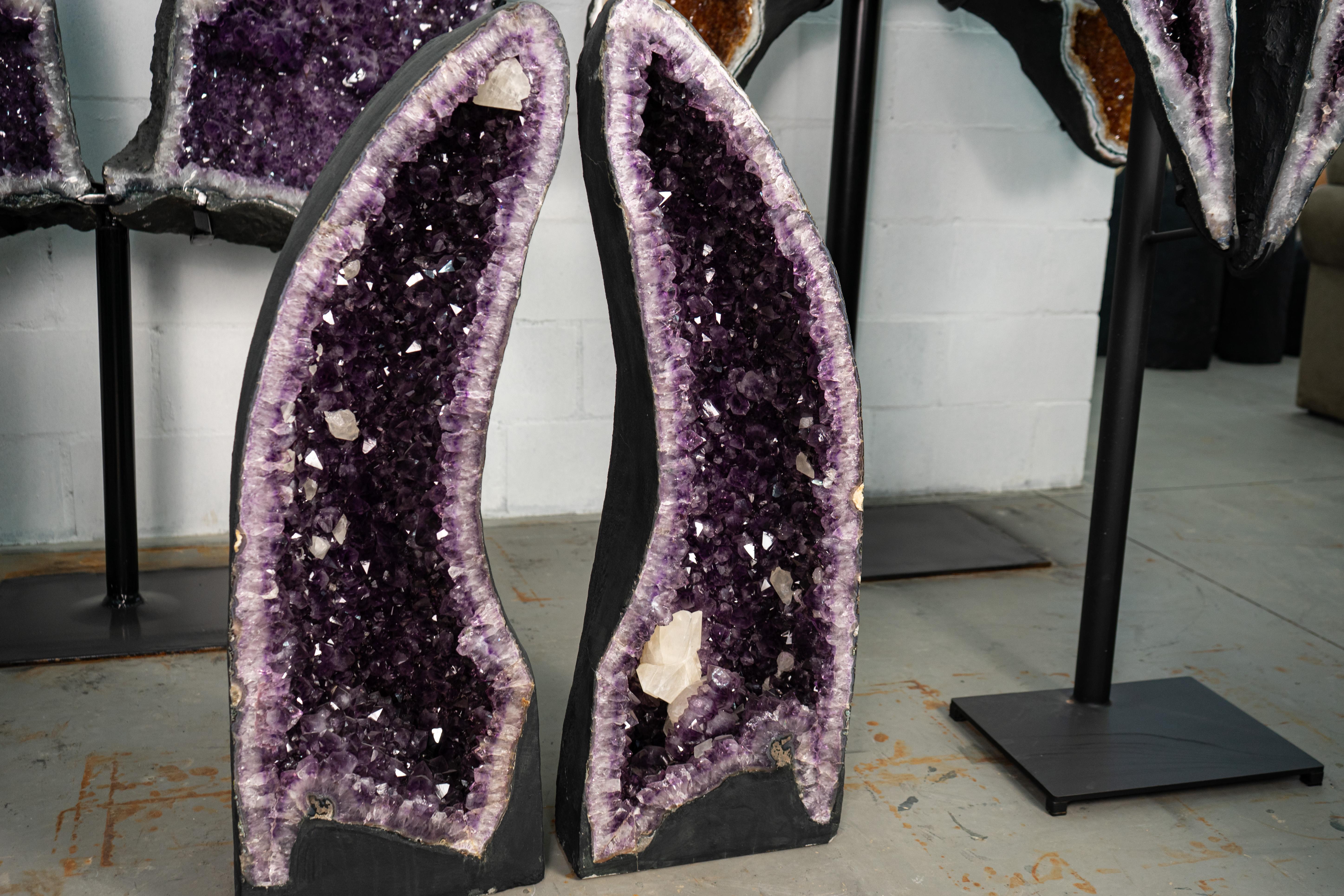 Pair of Book-Matching, with Symmetrical Arches Amethyst Geodes with Deep Purple Amethyst Druzy and Calcite Inclusion

▫️ Description

A pair of book-matching amethyst geodes showcasing remarkable features, including their symmetrical arched