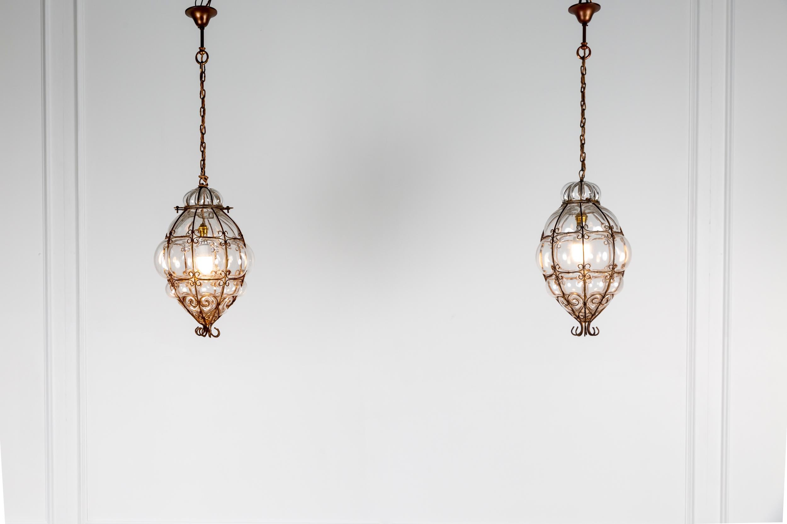 Pair of Archimede Segusomurano caged glass pendant lights.

The most beautiful pair of large hand blown murano caged glass pendant lights, by the master Venetian Glass Blower Archimede Seguso.

Casting a beautiful rippling light pattern to that of