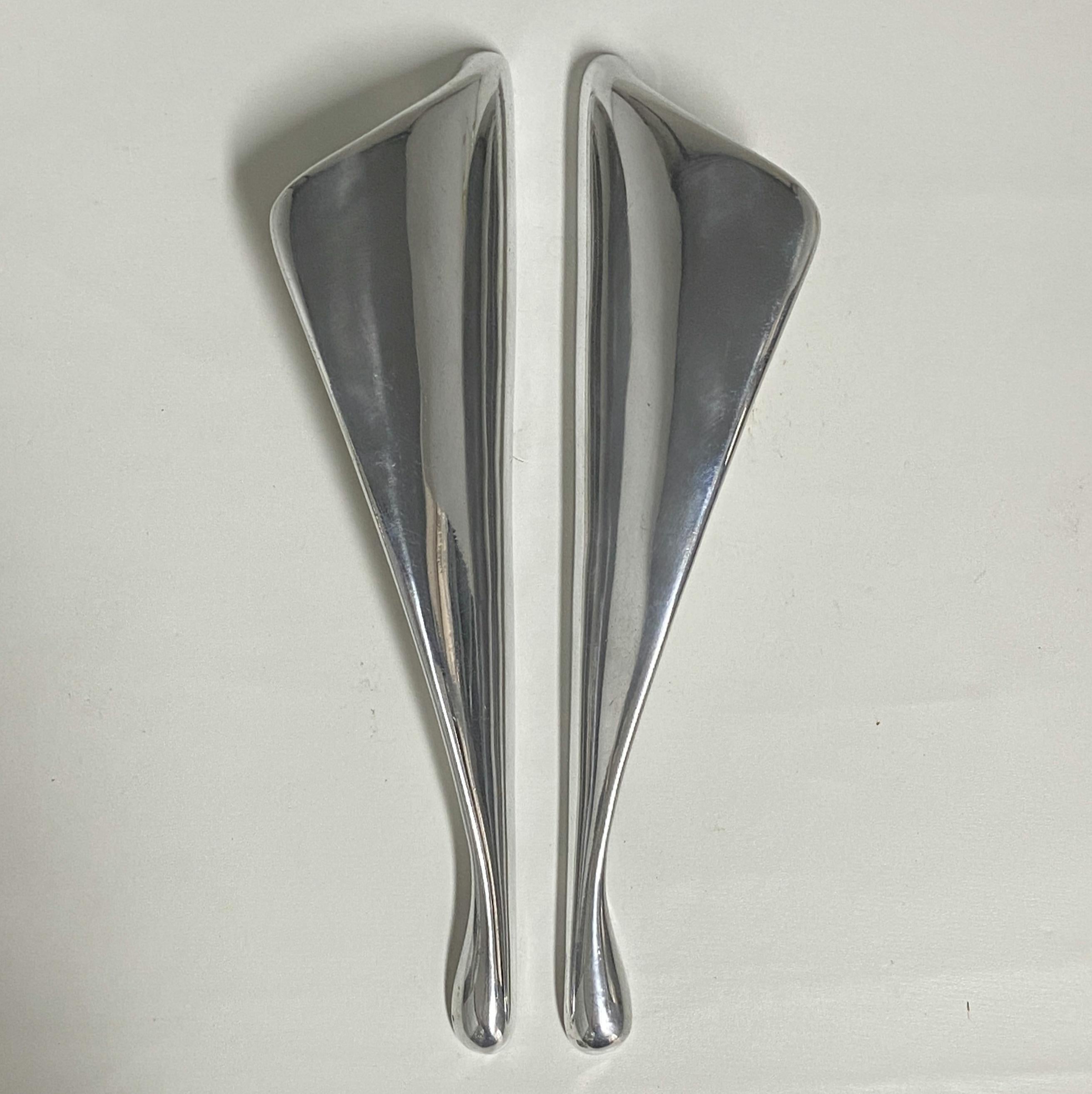 Pair of Mid Century Modern aluminum cast push and pull door handles shaped like wings. 
They will work inside or outside any contemporary building today. They can be used on furniture as well as on entry doors.
View all our listings by The Moderns,