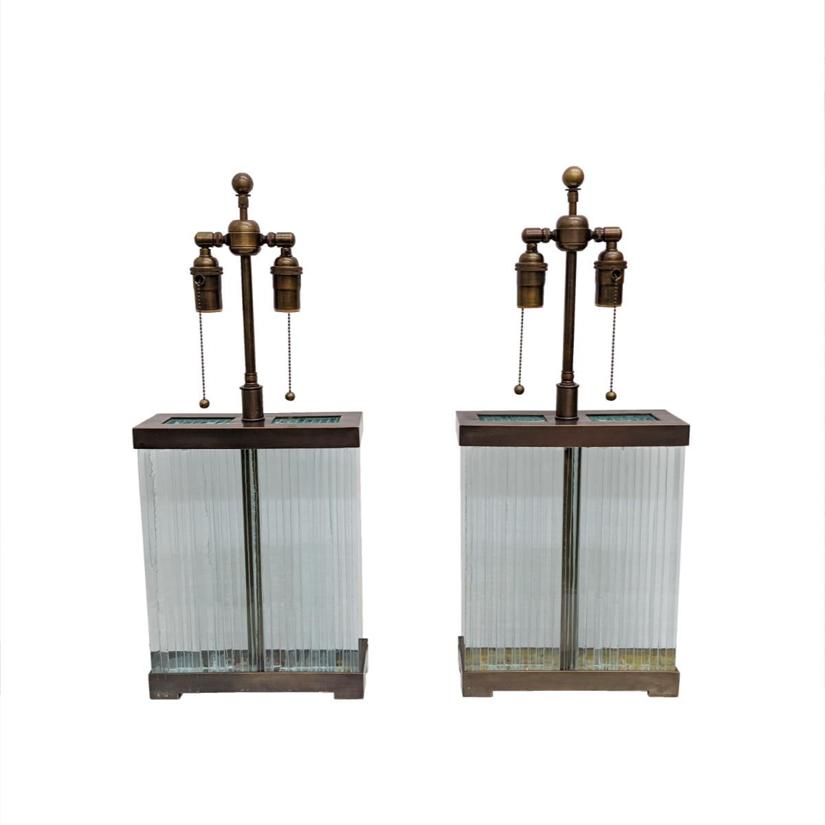 Pair of glass slab table lamps with patinated hardware in the manner of Jean Michel Frank by Marcelo Bessa.