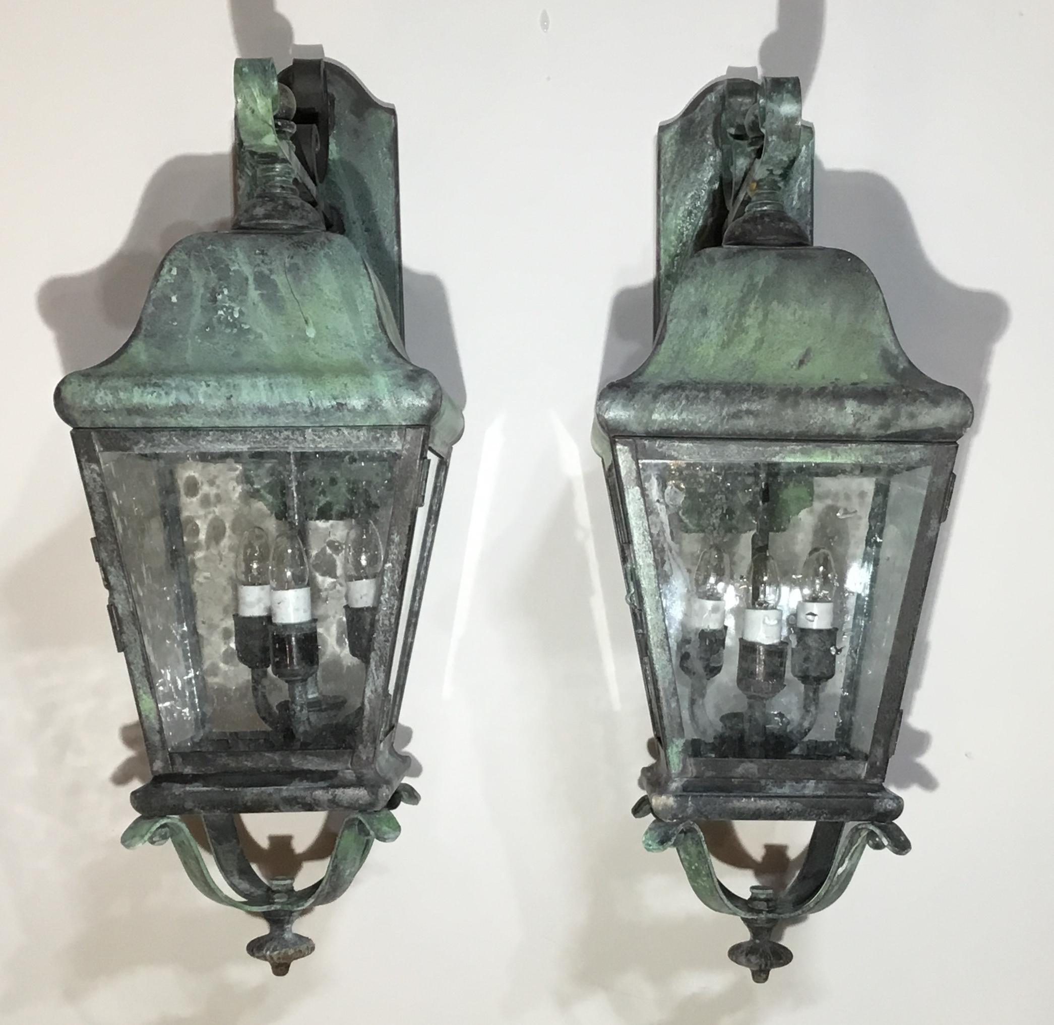 Impressive pair of lantern handcrafted from solid brass, electrified with cluster of three 40/watt lights each, and ready to hang. Seeded glass UL approved up to US code. Suitable for wet locations.
Very impressive for house enterce, or indoors as